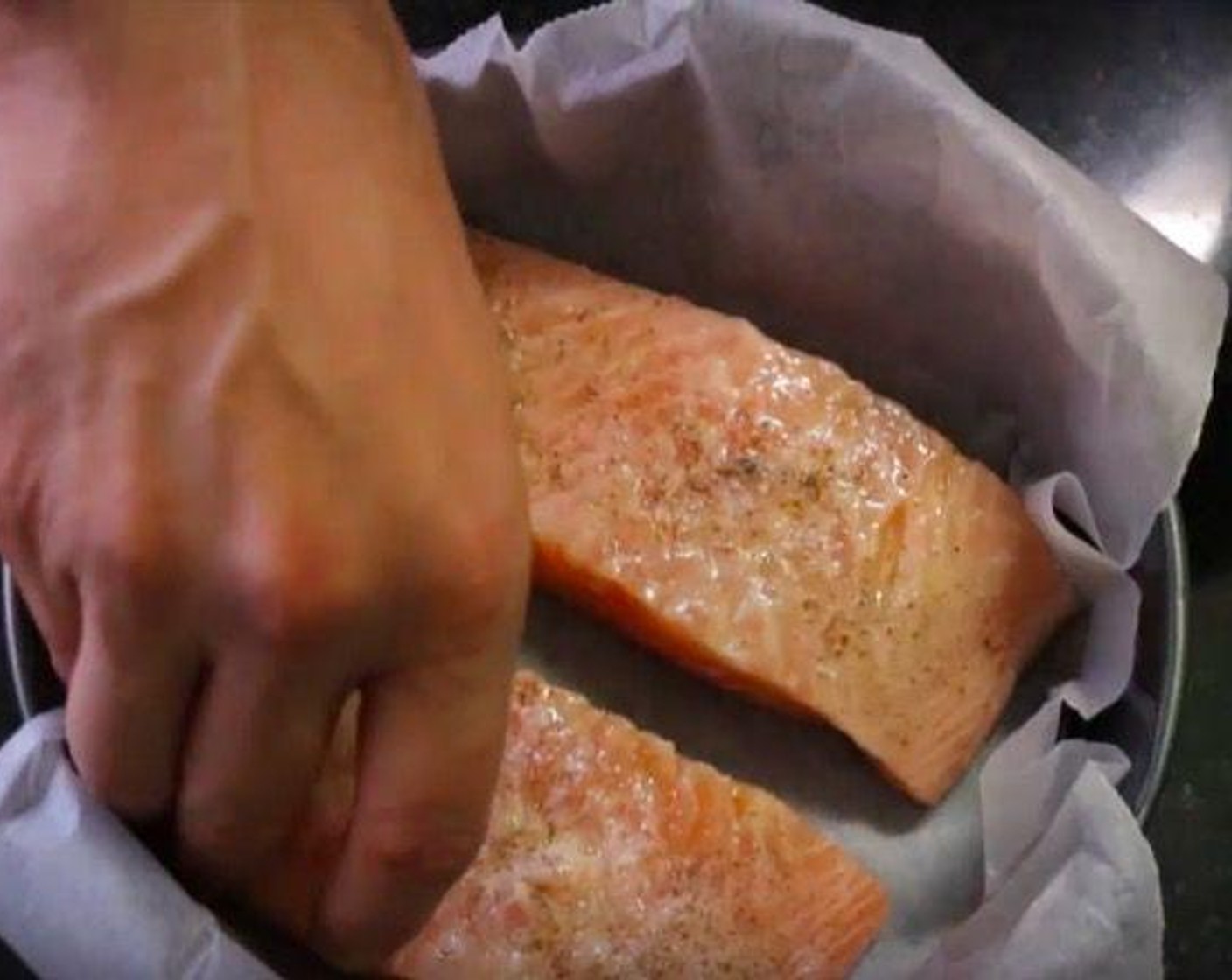 step 6 Drizzle Salmon Fillets (2) with Extra Virgin Spanish Olive Oil (1 Tbsp) and the juice from Lemon (1). Rub all over the fillets, then season with Sea Salt (to taste) and Ground Black Pepper (to taste). Add the salmon fillets to a baking dish lined with parchment paper.
