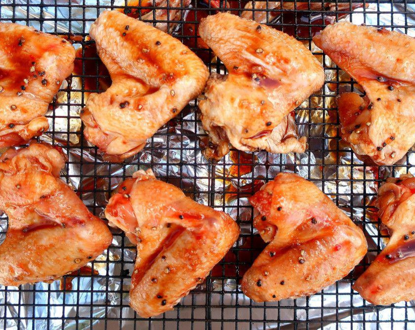 step 2 Season Chicken Wings (8) with Peanut Oil (as needed), Freshly Ground Black Pepper (to taste), Soy Sauce (to taste), Kosher Salt (to taste), Lemons (to taste), Chili Oil (as needed), Granulated Garlic (to taste), Hoisin Sauce (to taste), and Ground Annatto (to taste).