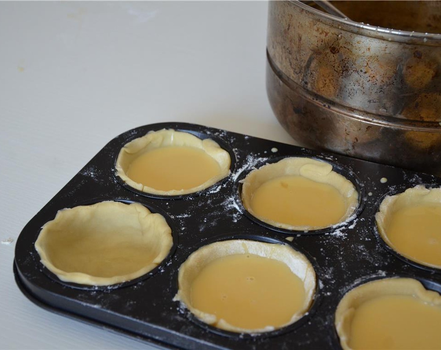 step 7 Fill the crusts to about three quartes with the custard.