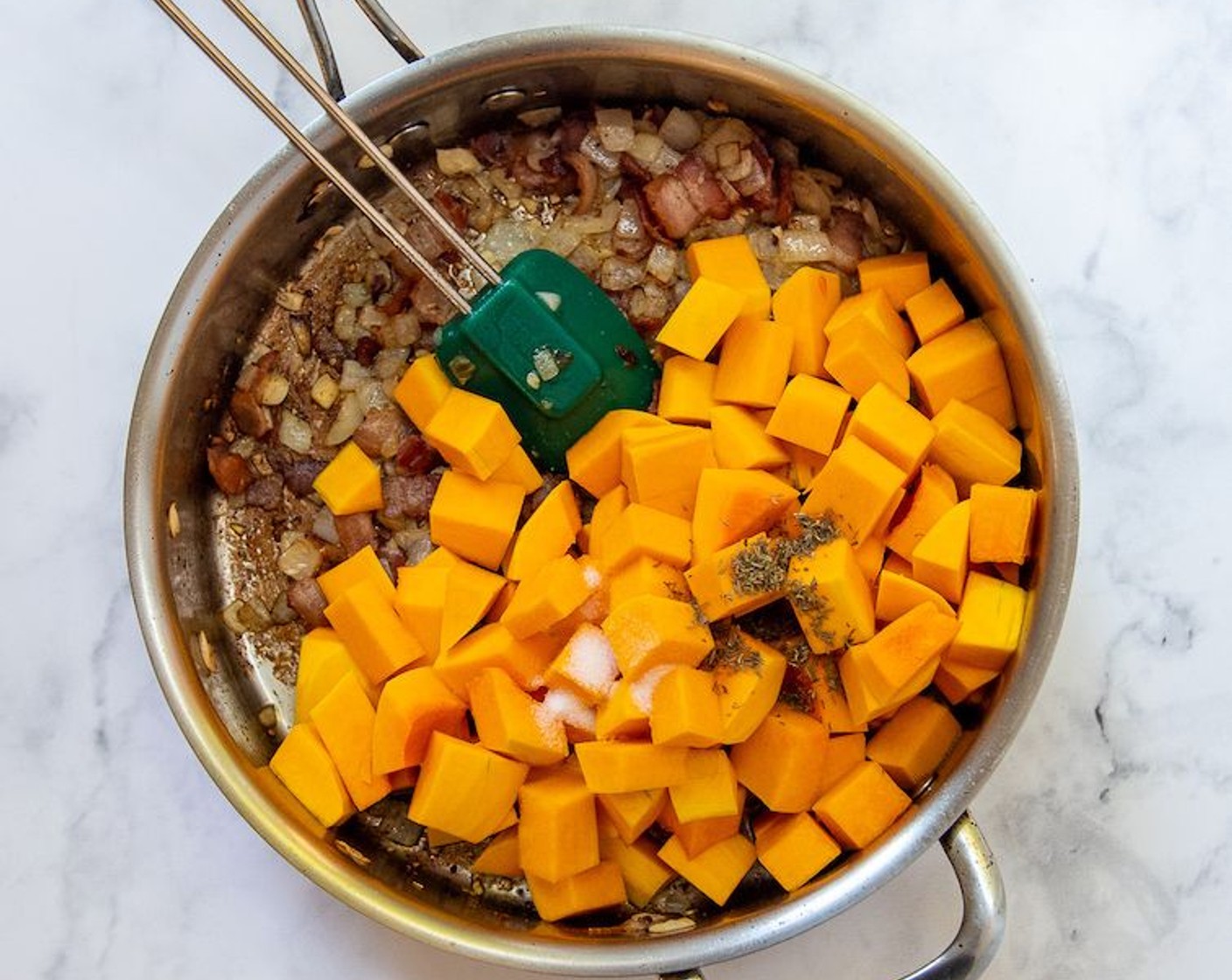 step 3 Add the Dried Thyme (1/2 tsp), Butternut Squash (1) and Salt (1/2 tsp). Stir to combine and coat squash in bacon drippings. Slowly pour in Chicken Broth (1 cup), scraping the bottom of pan with a silicone spoon to loosen all the browned bits. Bring to a boil, cover, and reduce heat to a simmer. Cook for about 10 minutes or until squash is fork tender.