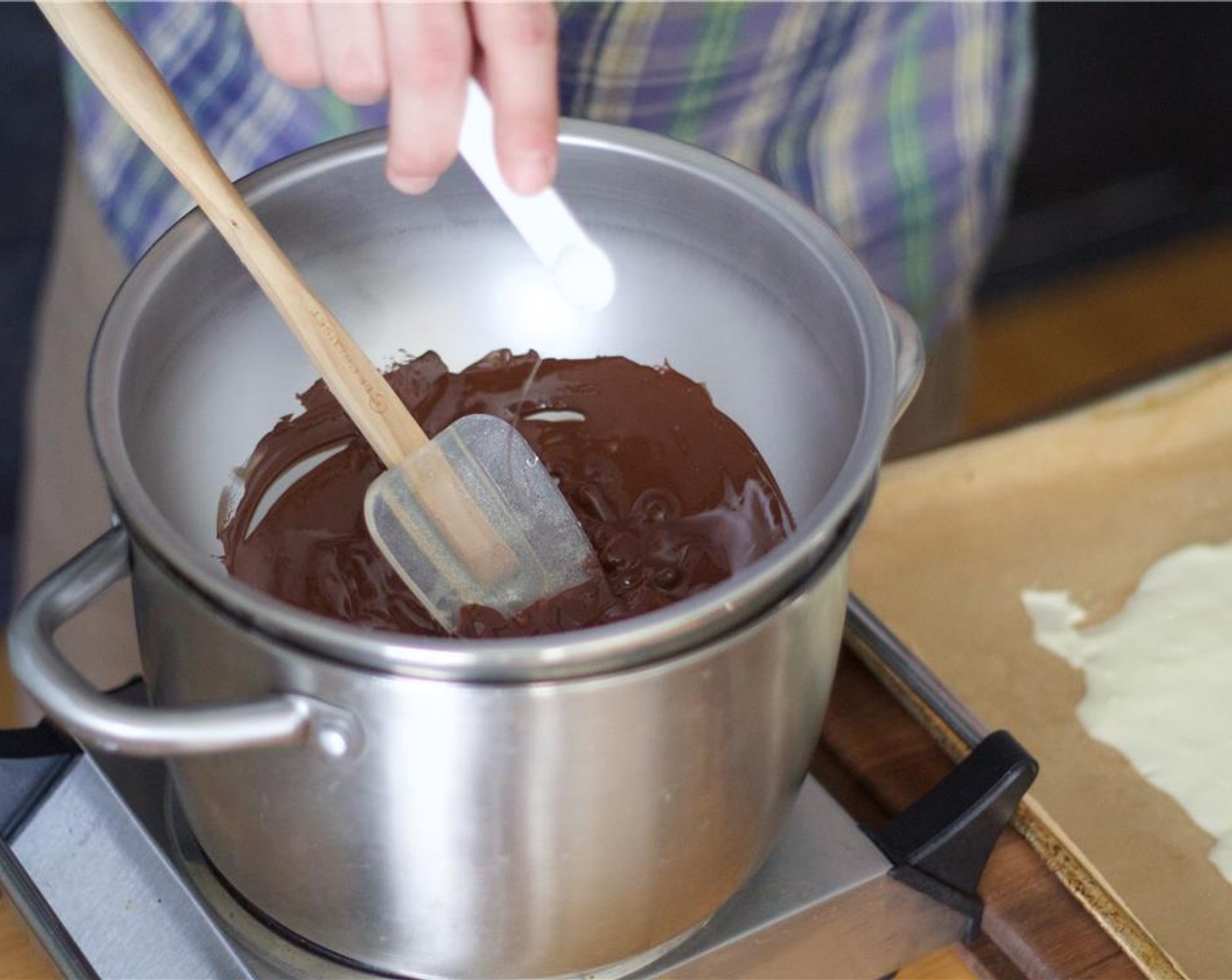 step 3 Place another clean bowl over the double boiler and immediately melt the Dark Chocolate (1/3 cup). Once fully melted, stir in the Rose Water (1/4 tsp).