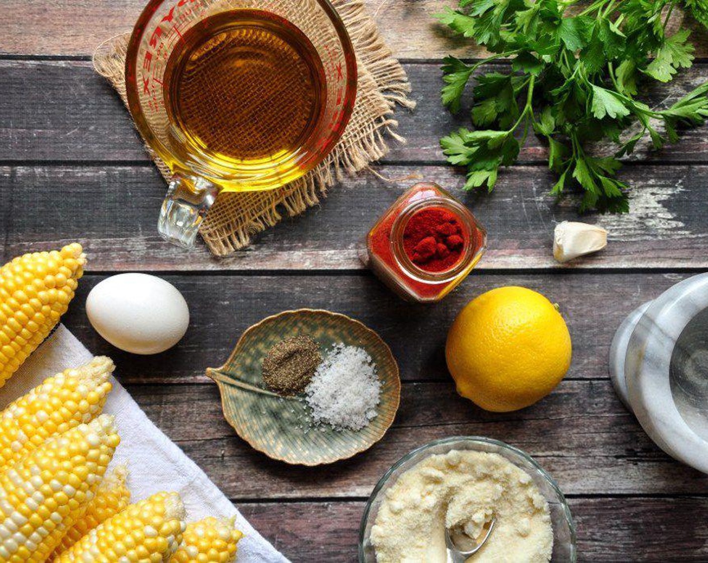 step 4 While the corn is baking, make the aioli. Smash up the Garlic (1 clove) with Salt (1 tsp) in a pestle and mortar (or use the end of a rolling pin in a metal bowl).