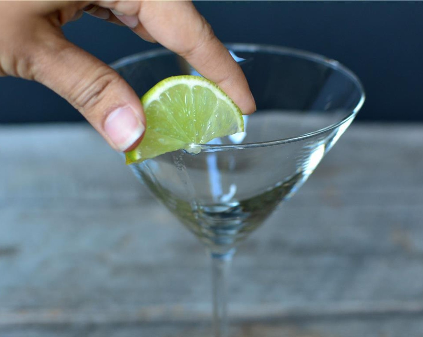 step 3 Rim the martini glass with sugar. Use a wedge of Lime Wedge along the rim of the glass to get it wet.