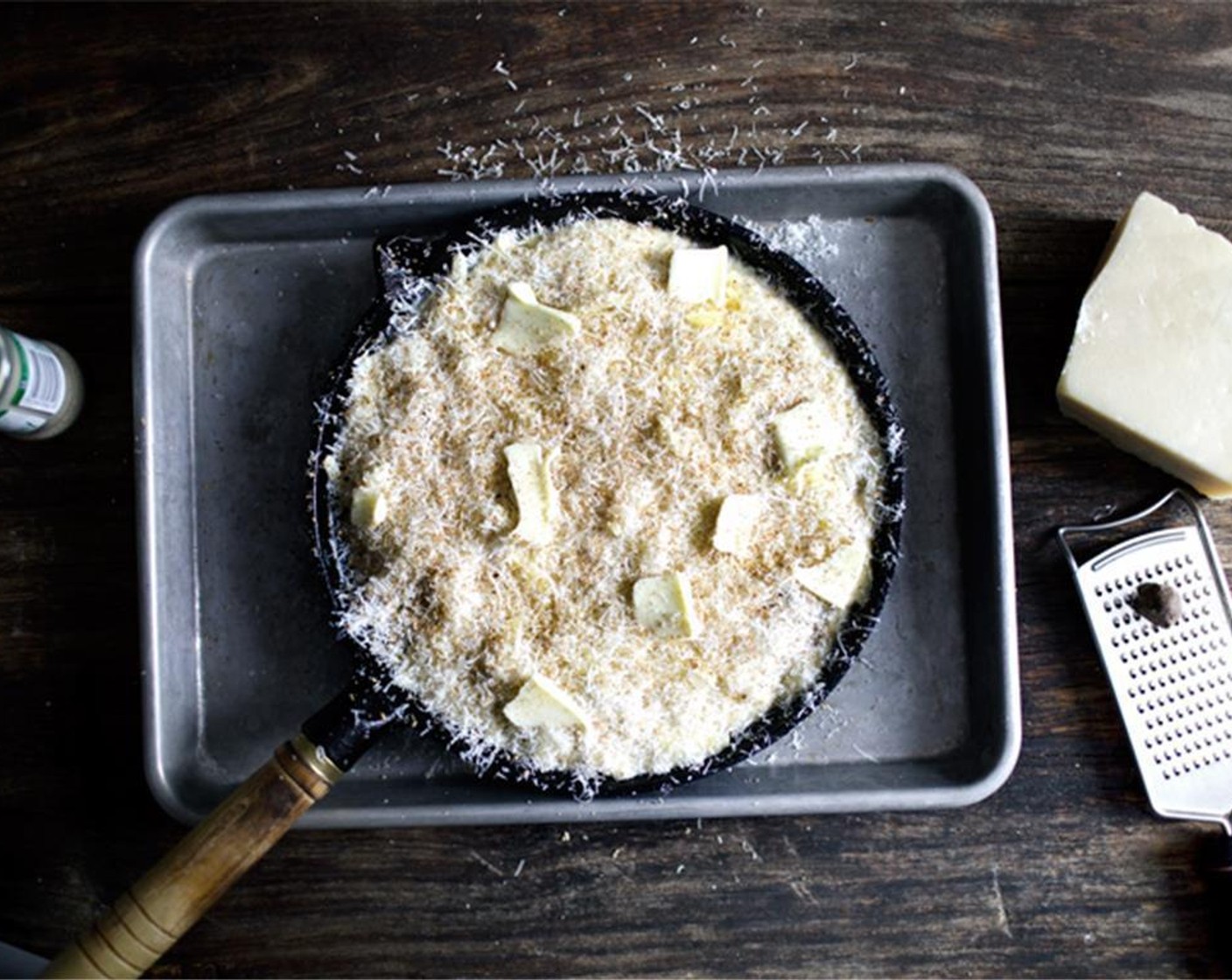 step 6 Top with Parmigiano-Reggiano (to taste) to entirely cover the surface, then scatter a few extra nubs of unsalted butter here and there. Bake on the middle rack of the oven for 13 to 15 minutes, until it's bubbly and golden browned.