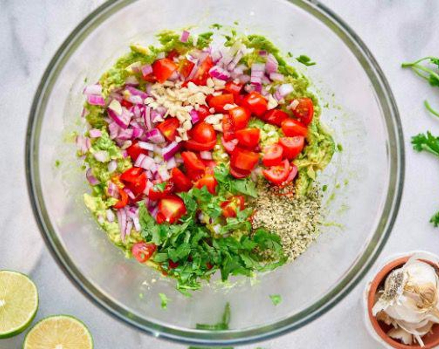 step 1 In a large bowl, stir in Avocados (4), Red Onion (1/4), Grape Tomatoes (3/4 cup), Hemp Hearts (3 Tbsp), Garlic (1 clove), and Limes (2).