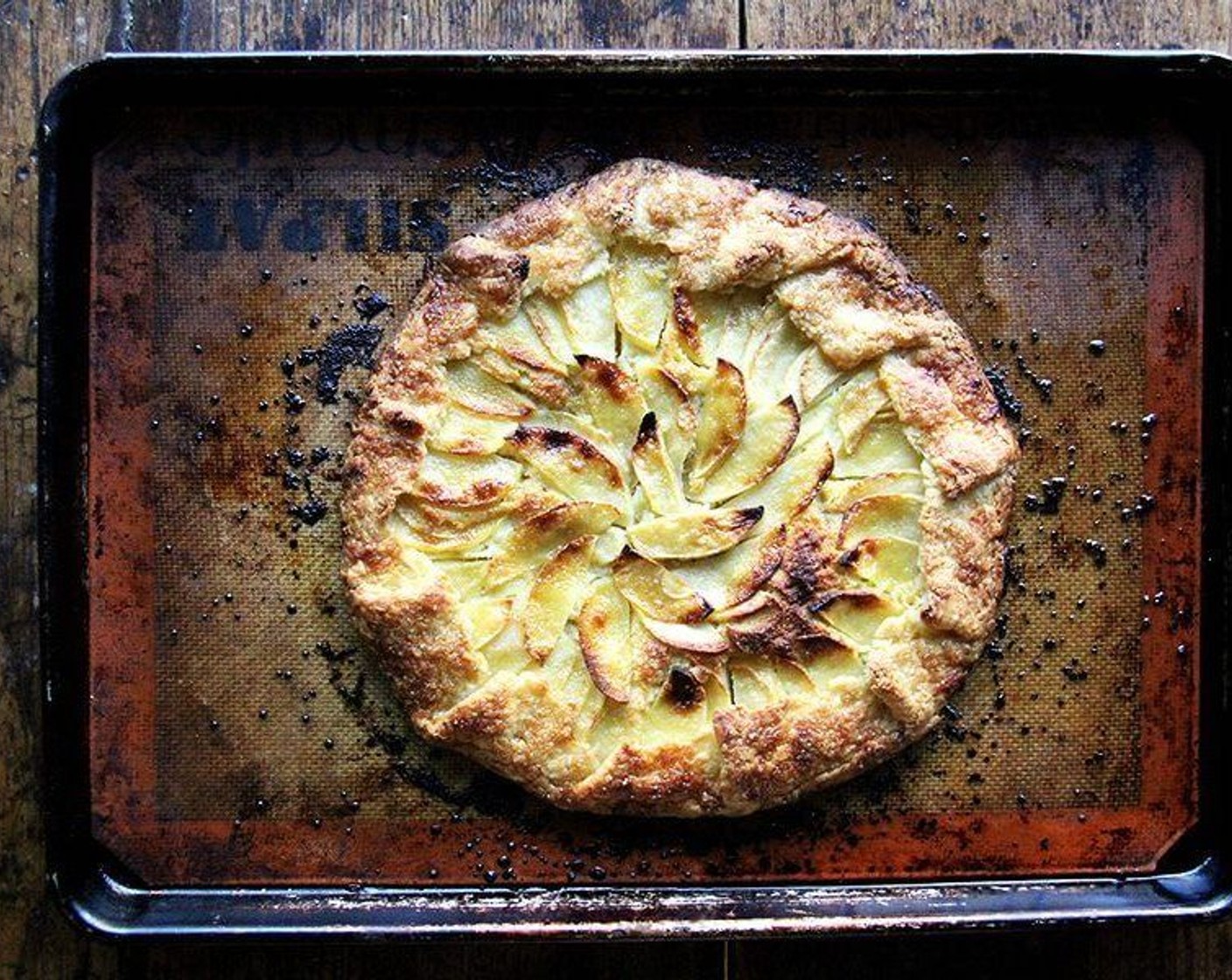 step 12 Remove pan from the oven and let rest on cooling rack for five to ten minutes or until Silpat or paper is cool enough to handle. Grab the edges of the paper or Silpat and slide to a cooling rack to cool further or to a cutting board to serve.
