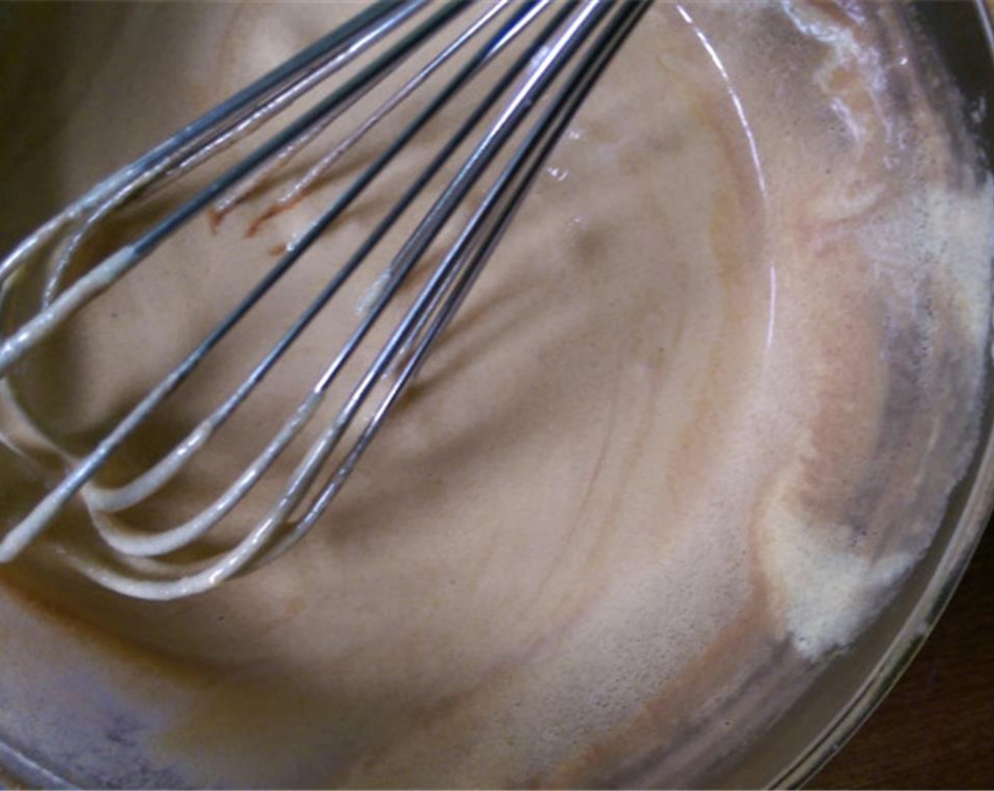 step 5 Add a tablespoon of hot chocolate/cream/milk mixture to the egg yolks while continuously whisking. Keep adding the hot mixture to the yolks until it is easy to pour.