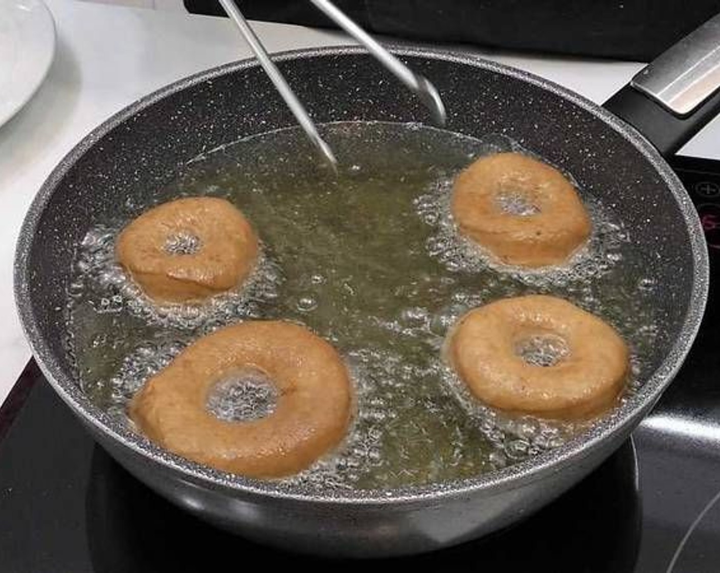 step 8 In a pan add Frying Oil (as needed) and heat on medium heat. Once the oil is hot, fry the donuts. Once golden brown flip and fry the other side.