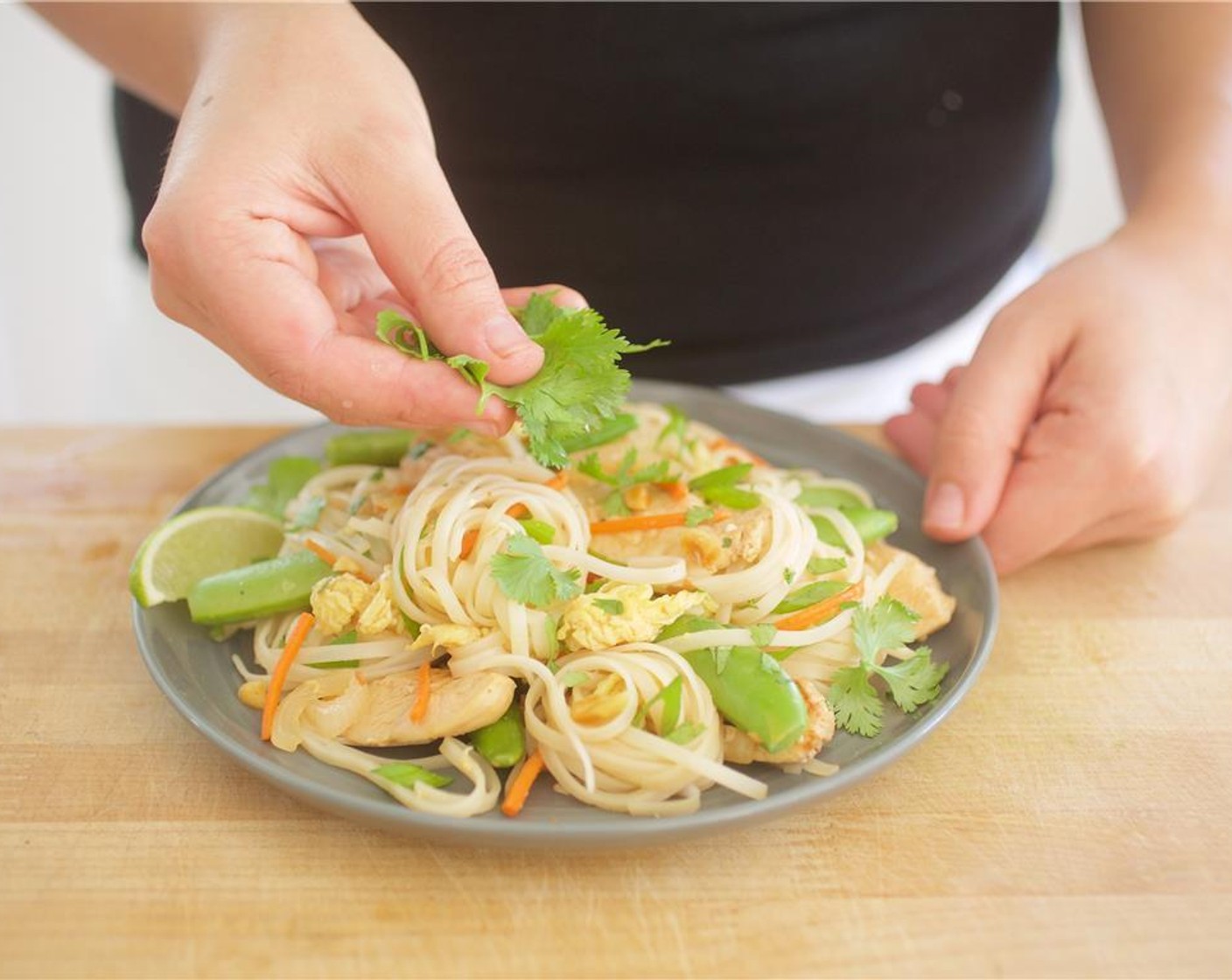 step 12 Add the noodles, matchstick carrots, chopped cilantro, Sugar Snap Peas (2/3 cup), Chopped Roasted Peanuts (2 Tbsp), and green onions. Toss until well coated and remove from heat.