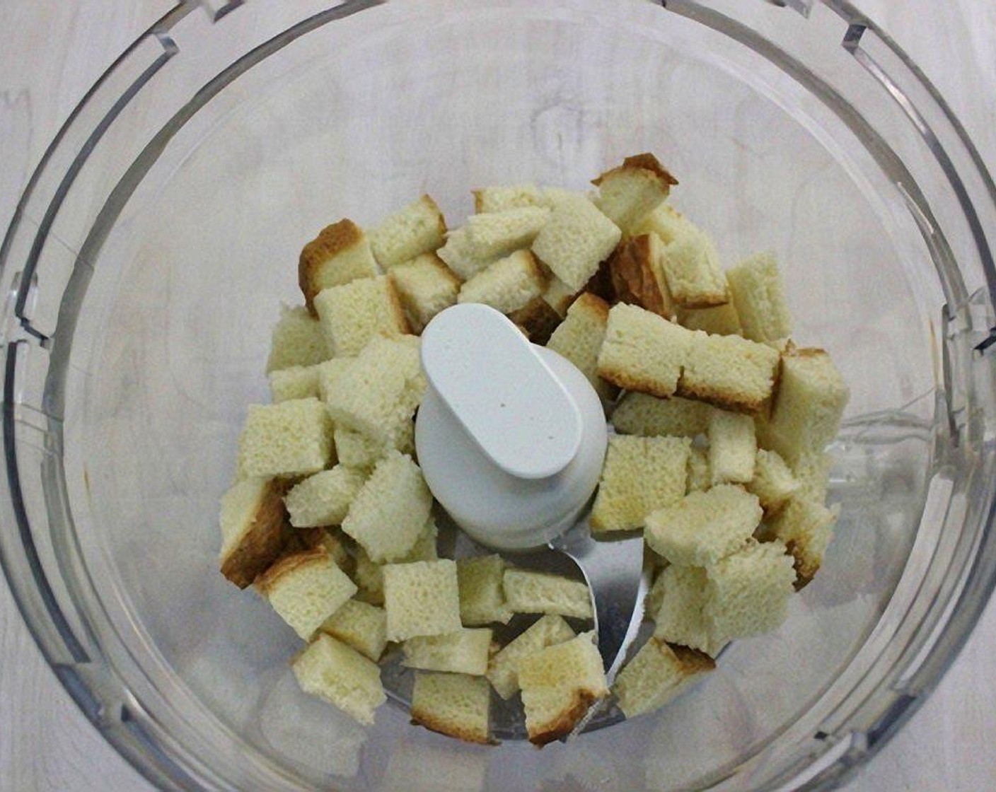 step 4 Make the seasoned breadcrumbs by cutting the Bread (4 slices) into cubes and then pulsing in the food processor to make fine crumbs.