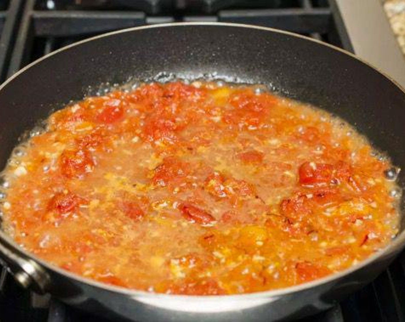 step 3 Crush Canned Diced Tomatoes (1 cup) with your hand and add to pan along with Aleppo Chili Flakes (1 pinch) and Saffron Threads (1 pinch). Simmer gently to reduce for 4 minutes.