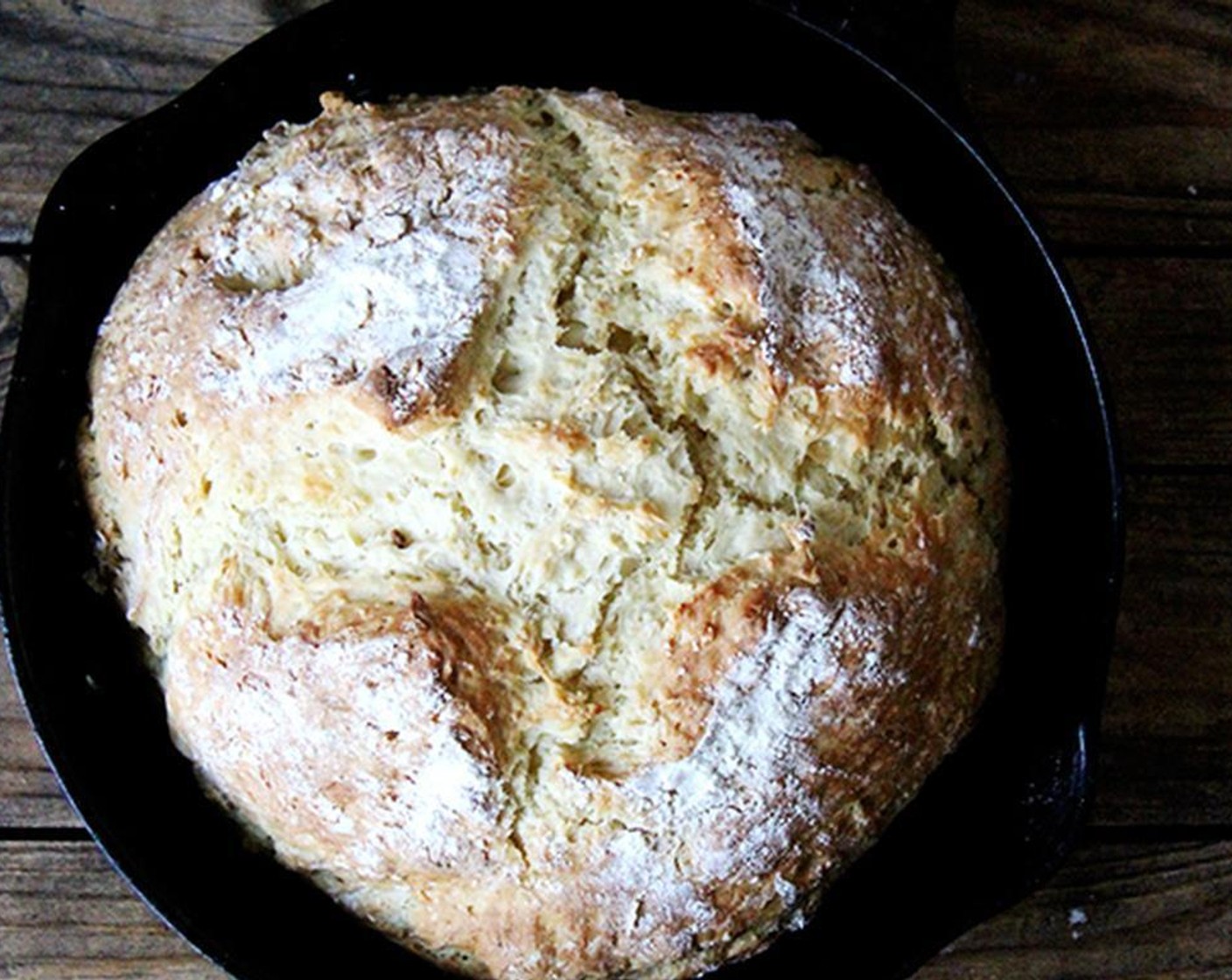 step 6 Sprinkle with a teensy bit more flour. Use a sharp knife to make an X across the top of the dough ball. Place in oven and bake for 35-40 minutes or until lightly golden and bottom sounds hollow when tapped.