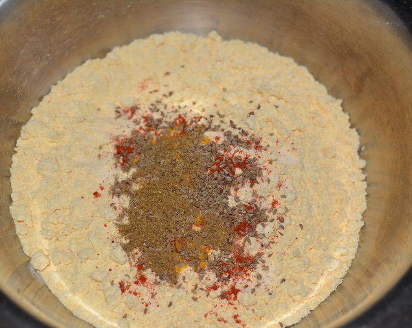 step 1 In a bowl, add Chickpea Flour (2 cups) with Ajwain Seeds (1 tsp), Red Chili Powder (1/2 Tbsp), Ground Turmeric (1 pinch), Garam Masala (1/2 Tbsp) and Salt (to taste).
