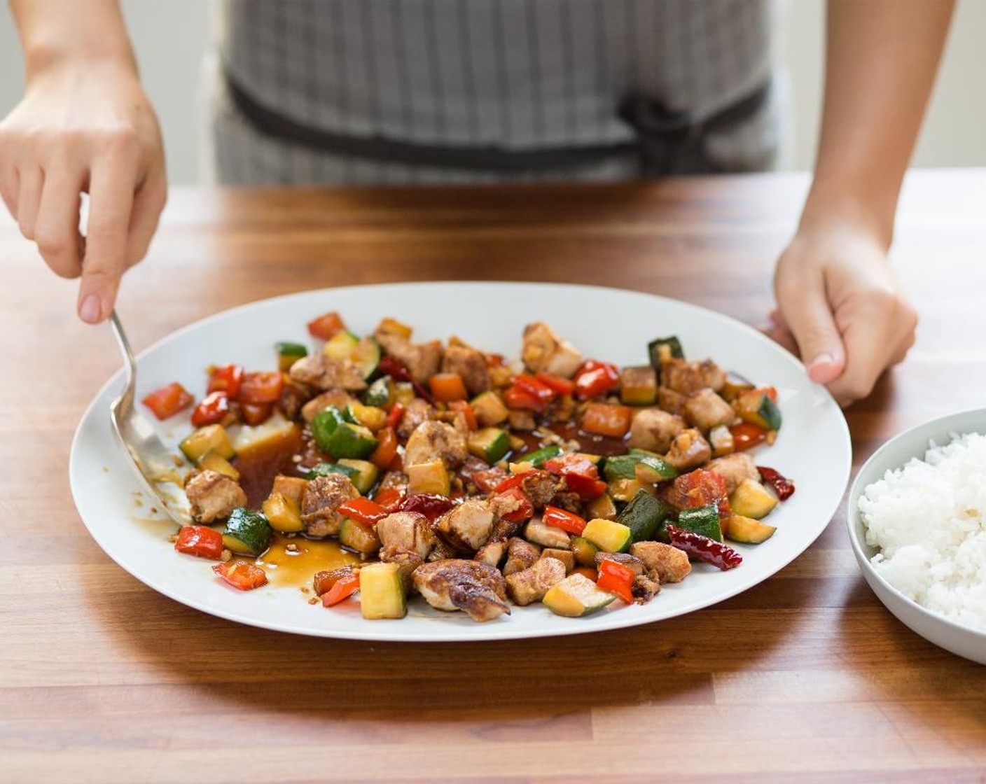 step 12 Divide the jasmine rice evenly between two bowls. Top with the Fire Pepper Chicken and drizzle each serving with the Sesame Oil (1 Tbsp). Serve and enjoy!