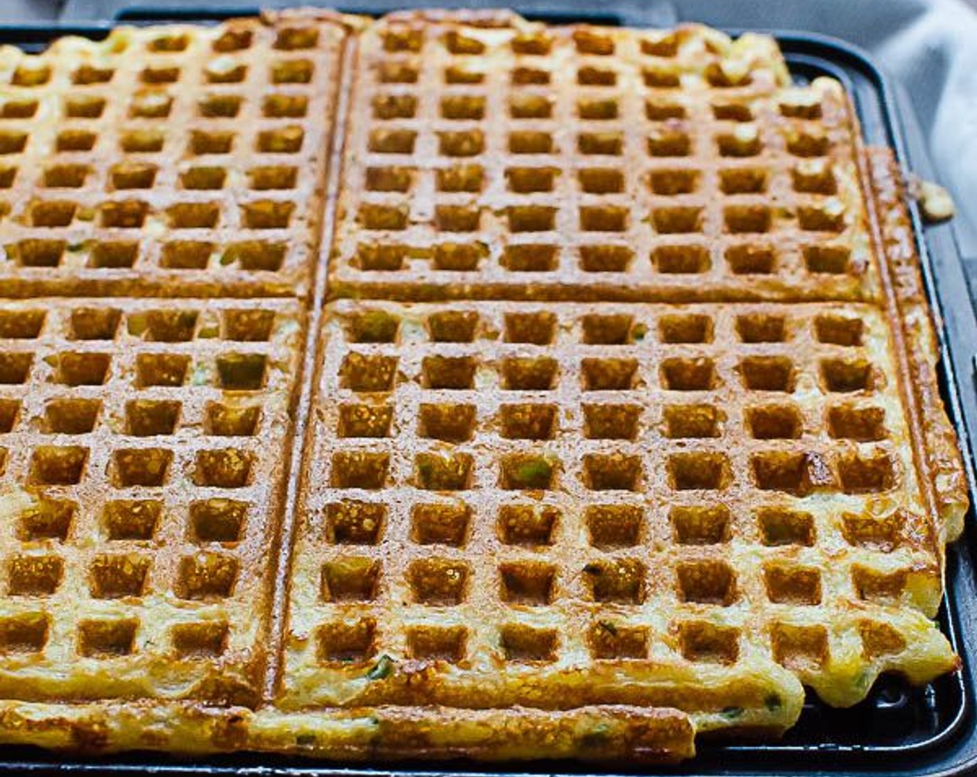 step 12 Preheat the waffle iron. Lightly coat with Vegetable Oil Cooking Spray (as needed), if necessary. Scoop batter onto the center of the waffle iron. Close the lid and bake until browned and crisp, about 5 to 7 minutes.