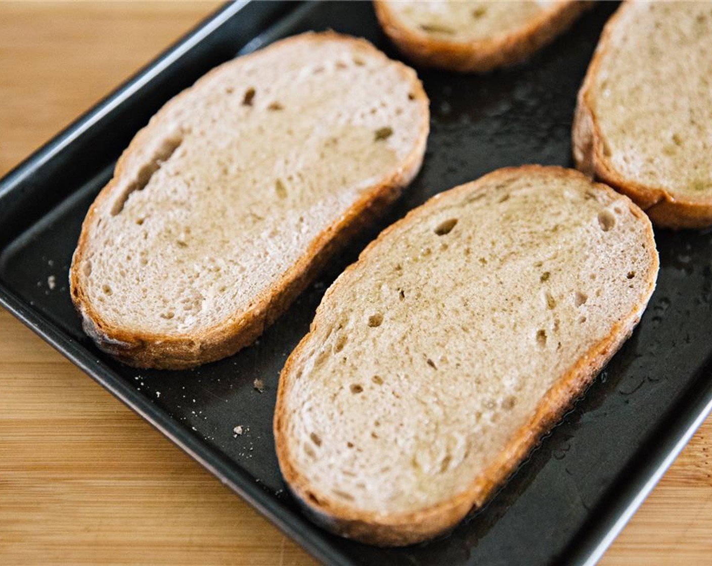 step 8 Place slices on a baking dish and drizzle with Olive Oil (as needed).