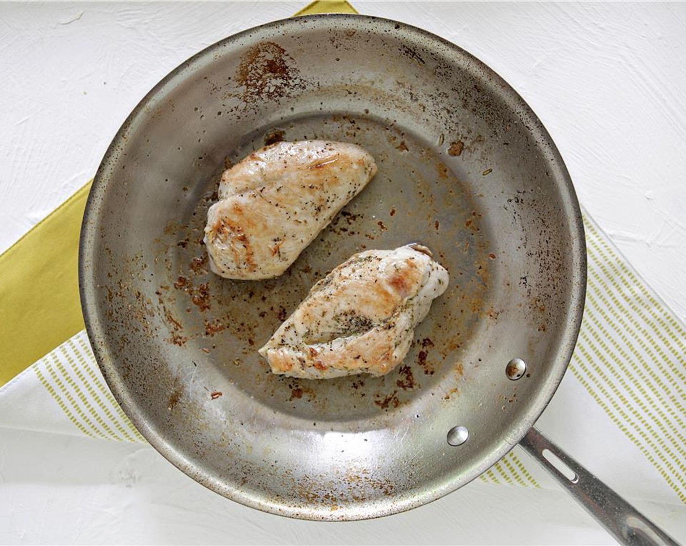 step 5 Heat a large saute pan over medium-high heat, then add Vegetable Oil (1 Tbsp). When hot, cook chicken breasts until browned on first side, flip, and continue cooking. When chicken is cooked through, remove from the pan, and set aside.