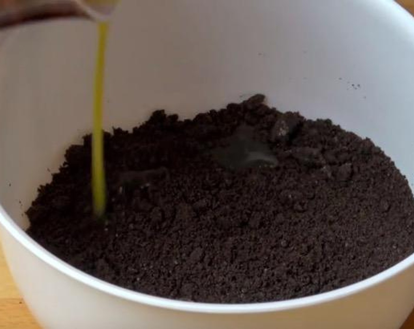 step 2 Take the remainder, which is the largest portion of the crushed cookies and add Butter (2 oz) into it. Mix them together until it gains a wet-sand like consistency.