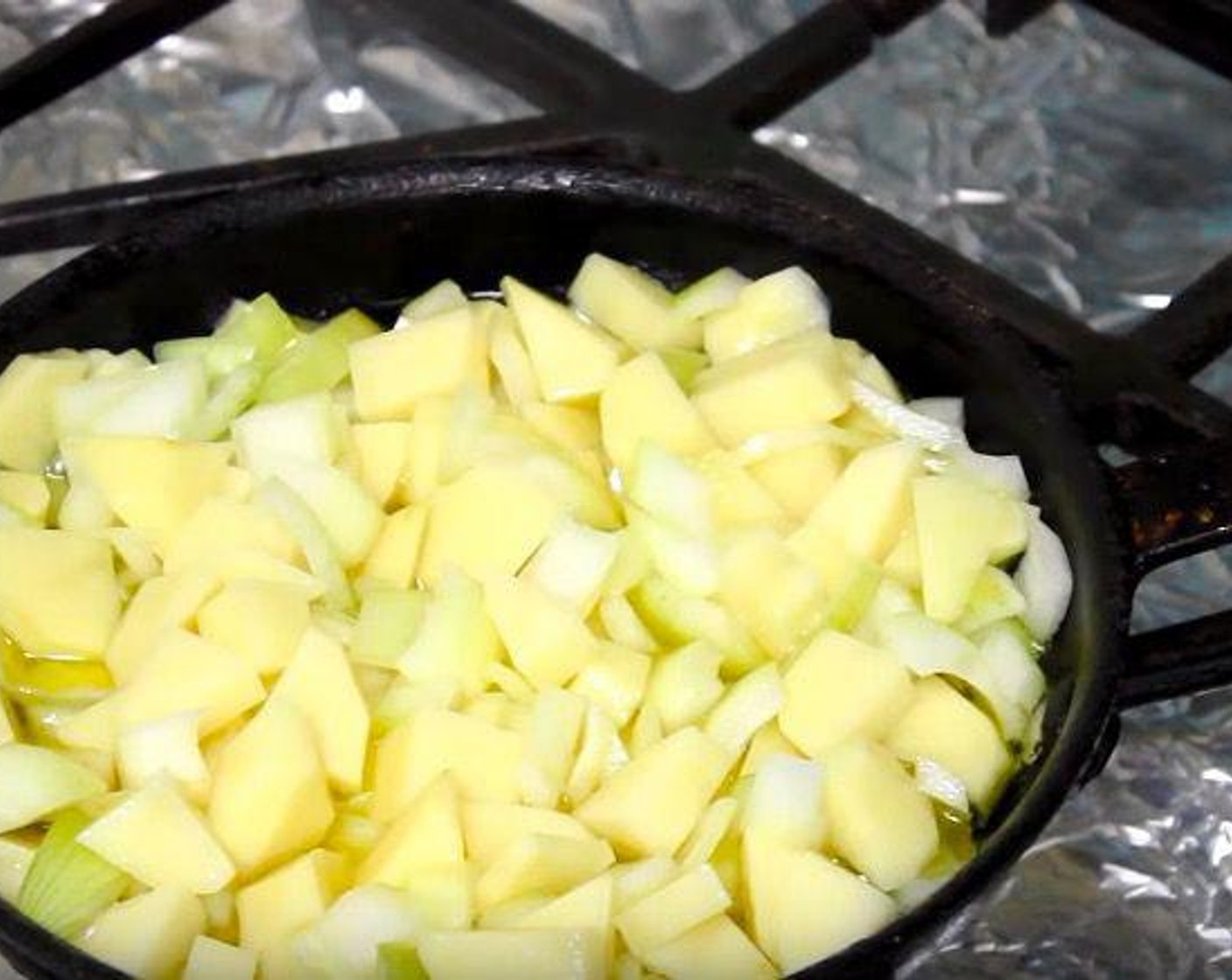 step 2 In a frying pan, heat Extra-Virgin Olive Oil (3/4 cup). Add potato and onion mixture. Cook for 18-20 minutes, stirring occasionally, until potatoes are tender. Remove with a slotted spoon and transfer to a clean mixing bowl.