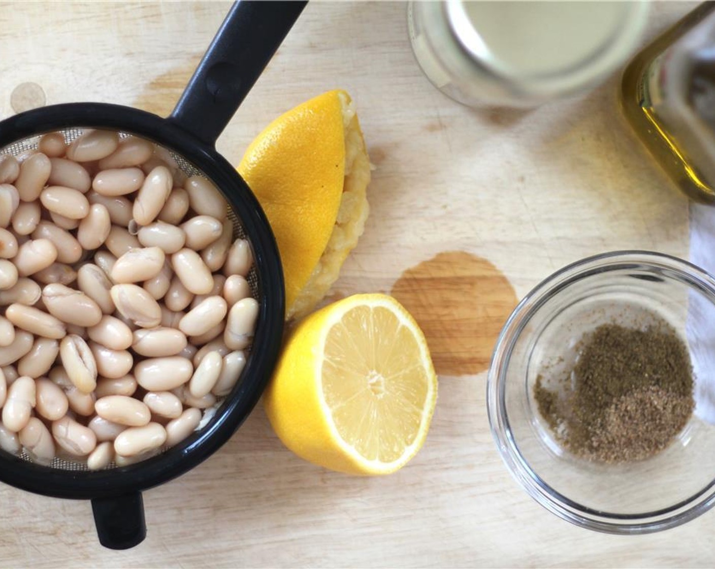 step 4 In a food processor or blender, blend together the Canned Cannellini White Kidney Beans (1 cup), the juice from Lemon (1/8), Dill Pickle (1), Pickle Juice (1 Tbsp), Greek Yogurt (2 Tbsp), Tahini (2 Tbsp), Olive Oil (2 Tbsp), Ground Cumin (1 tsp), and Ground Coriander (1 tsp).
