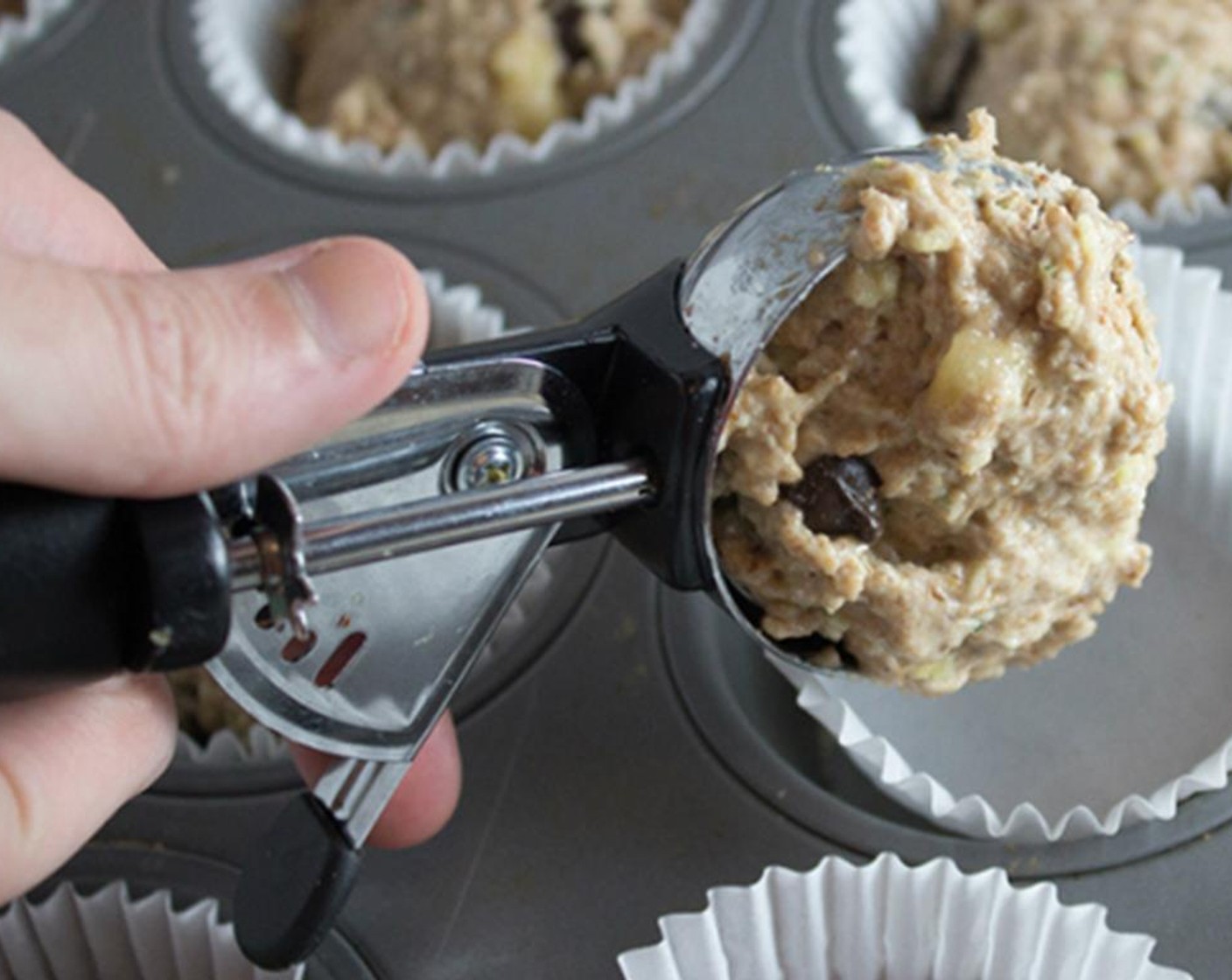step 7 Use an ice cream scoop to place the batter into the muffin liners.