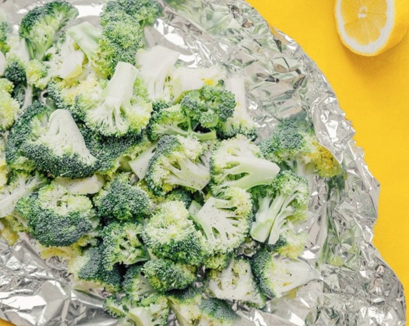 step 2 Chop Broccoli (1 head) into florets, then set on a large sheet of aluminum foil. Throw on the Garlic (4 cloves) and drizzle with Olive Oil (1 tsp). Cover with more foil and pinch together to form a sealed pouch.