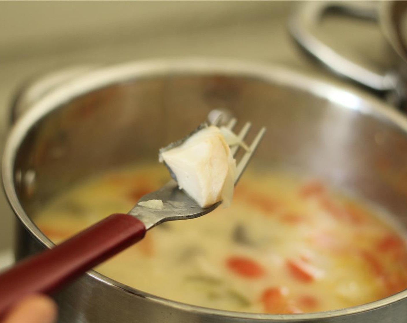 step 6 Add Salt (to taste) and Ground Black Pepper (to taste). Stir in the cubed fish and cook for 5 minutes, until the fish is cooked through and flaky.