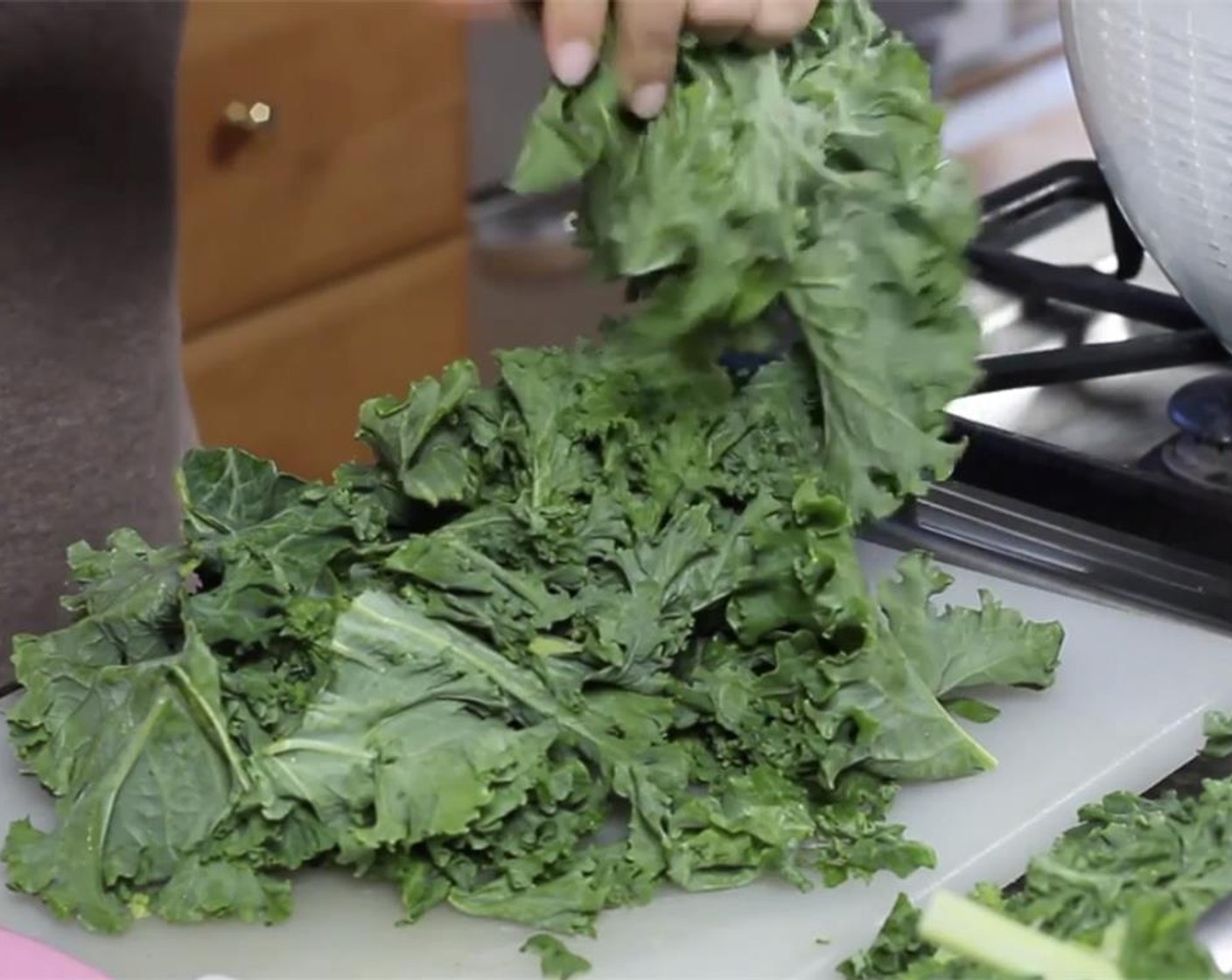 step 1 Strip the leaves from the stalks of the Kale (1 bunch) by grabbing the leaves and pulling away from the stalk.