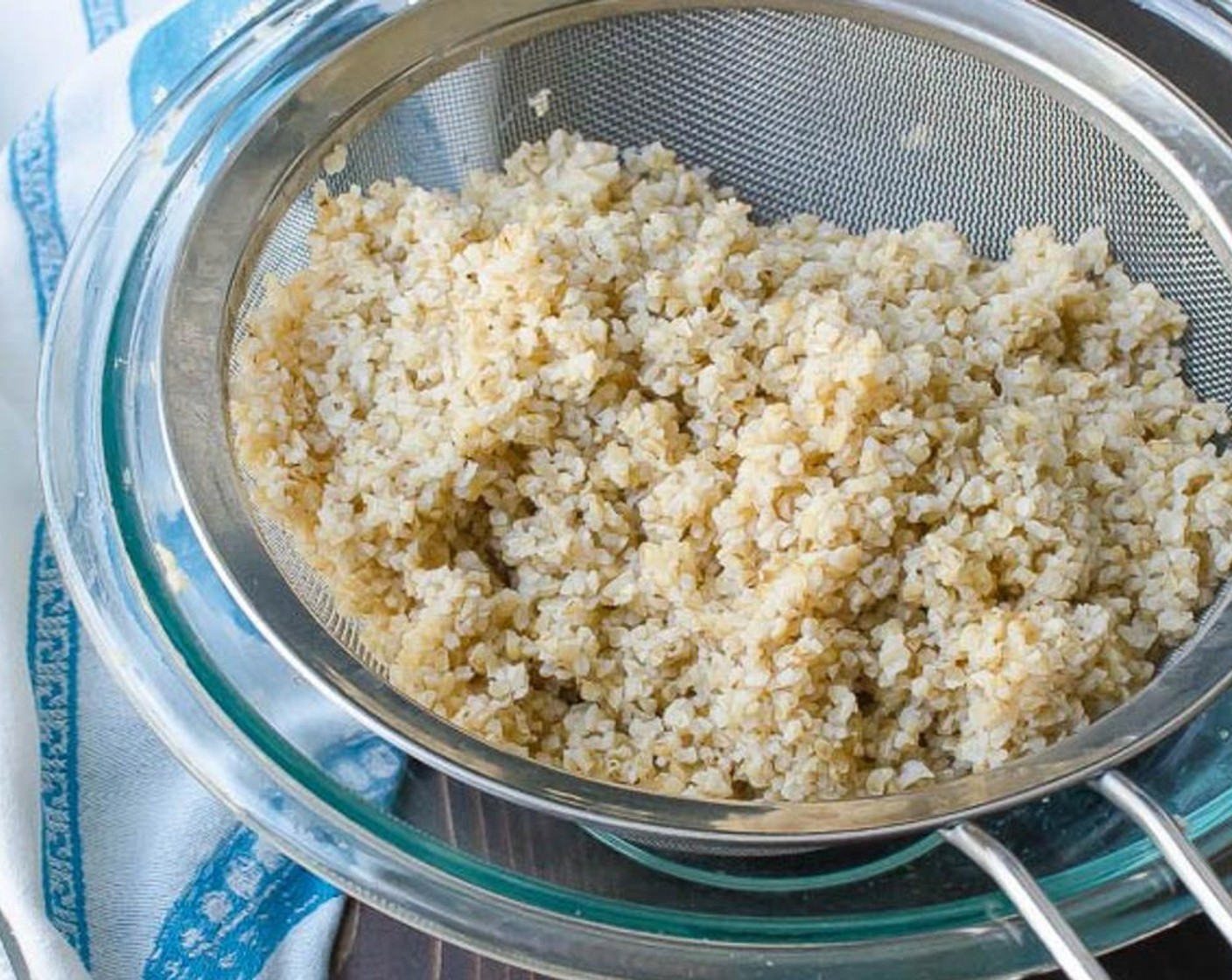 step 3 Pour the bulgur into a fine mesh sieve and set over the bowl to drain any excess water for 5 minutes. Transfer the bulgur to a large mixing bowl and add the Lemons (to taste) juice. Toss to combine.