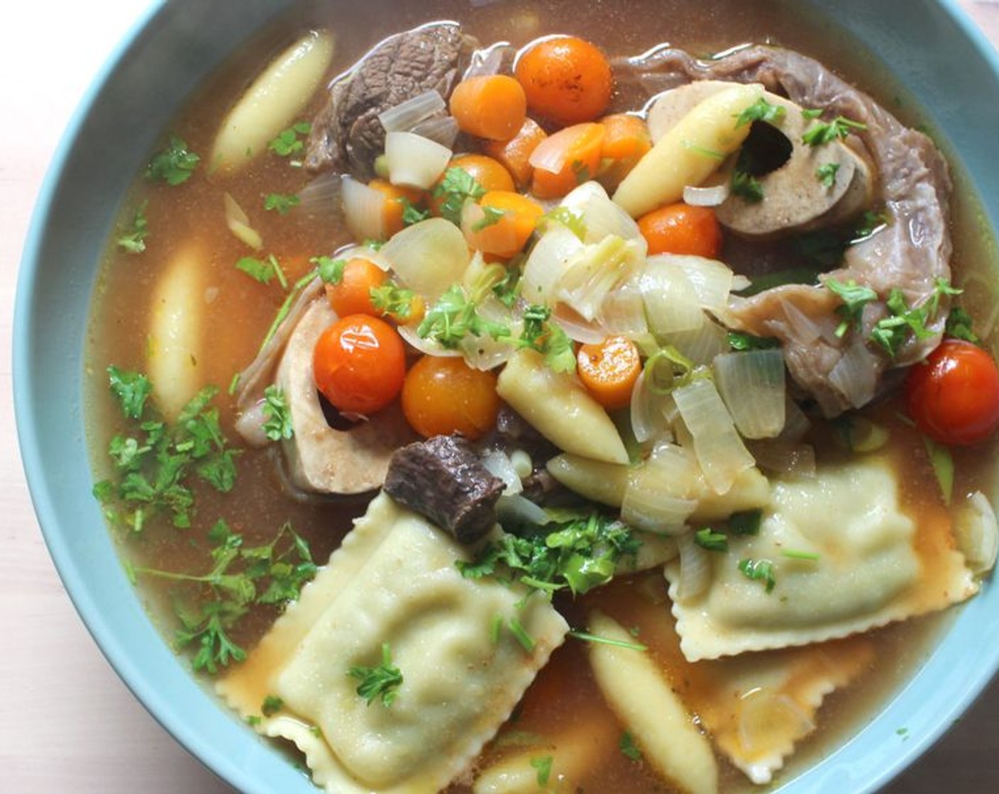 step 10 Place the beef on the bottom of a serving bowl, top with the soup, pasta, and veggies.