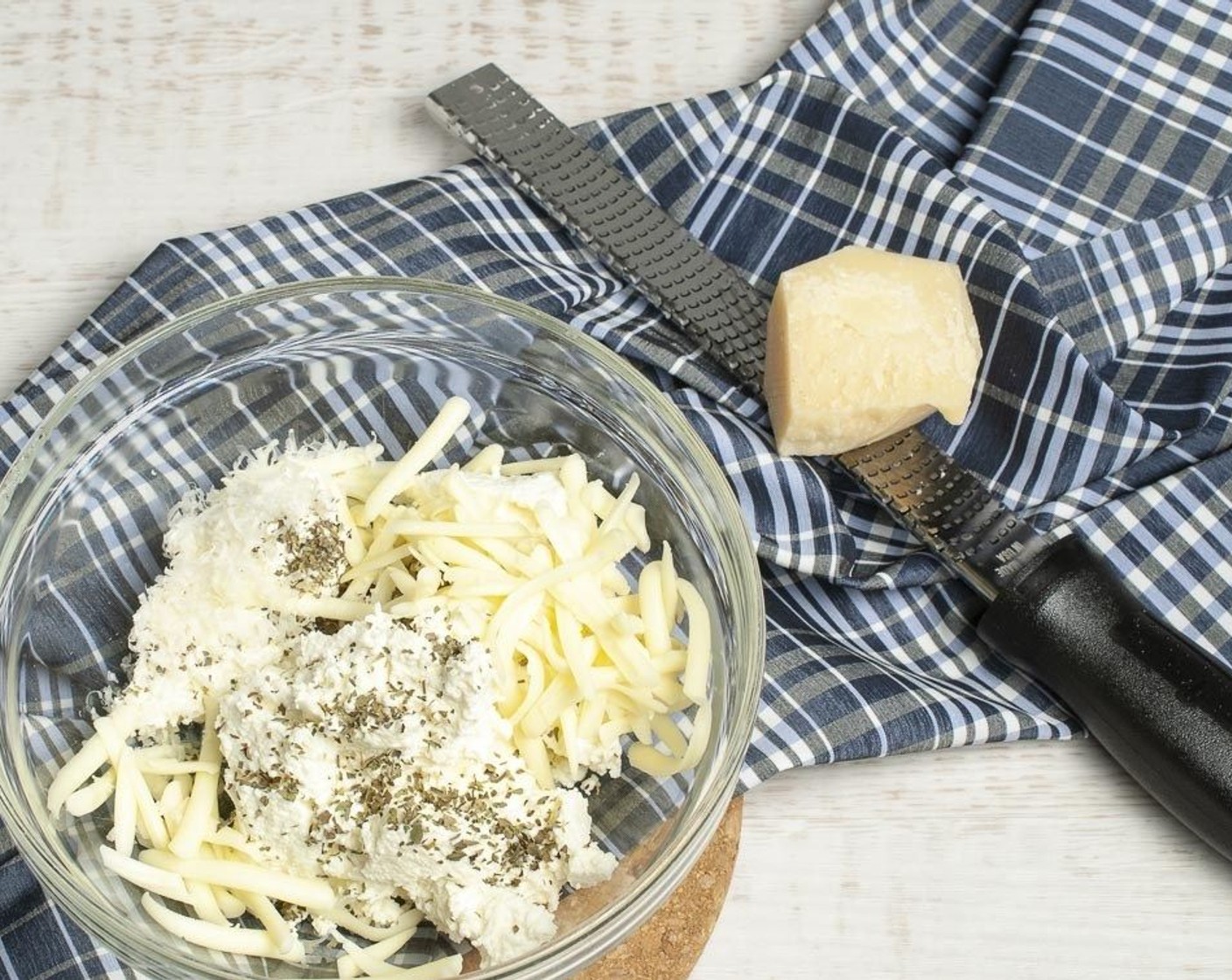 step 7 In a small bowl stir together Ricotta Cheese (1 1/2 cups), Shredded Mozzarella Cheese (3/4 cup), Grated Parmesan Cheese (4 Tbsp), Dried Basil (1 tsp), and a sprinkle of Salt (to taste) and Ground Black Pepper (to taste).