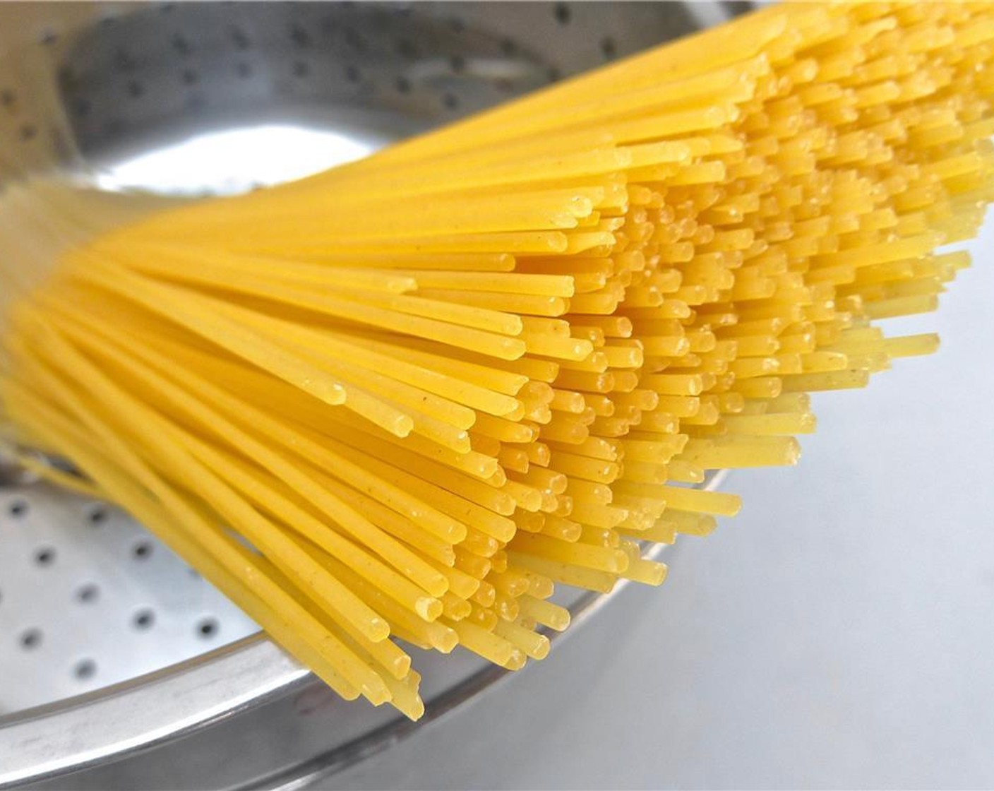 step 5 In the meantime fill a large and high pan with water, season with a good dash of Salt (to taste) and bring it to a good boil. Then add the Spaghetti (1 lb). Cook the pasta until al dente and then drain it.