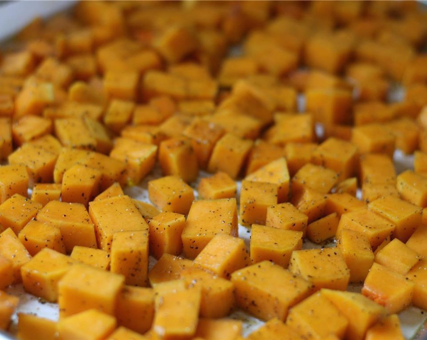 step 5 Toss squash cubes with Olive Oil (2 Tbsp), Cayenne Pepper (1 pinch), Smoked Paprika (1 tsp), Salt (1 tsp) and Brown Sugar (to taste).
