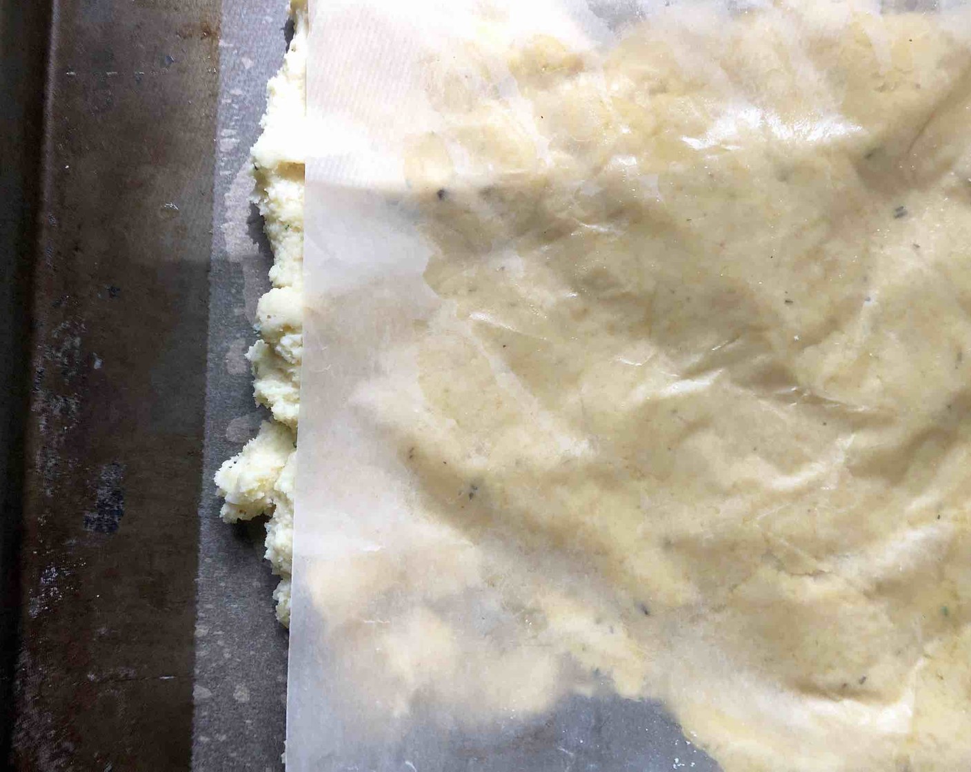 step 8 Lightly oil a piece of waxed paper and lay it over the dough. Press very gently to spread the dough and form the rectangular focaccia. Dimple it with your fingertips by pressing them gently into the dough, leaving depressions.