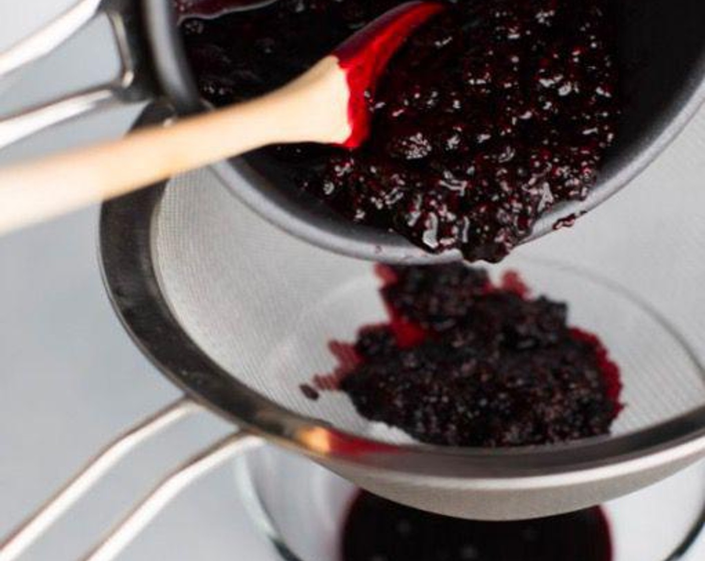 step 3 Strain raspberry mixture through a fine sieve to remove seeds. Press berries against the sieve walls to fully extract the juice. It will yield about 1/2 cup of filtered juice.