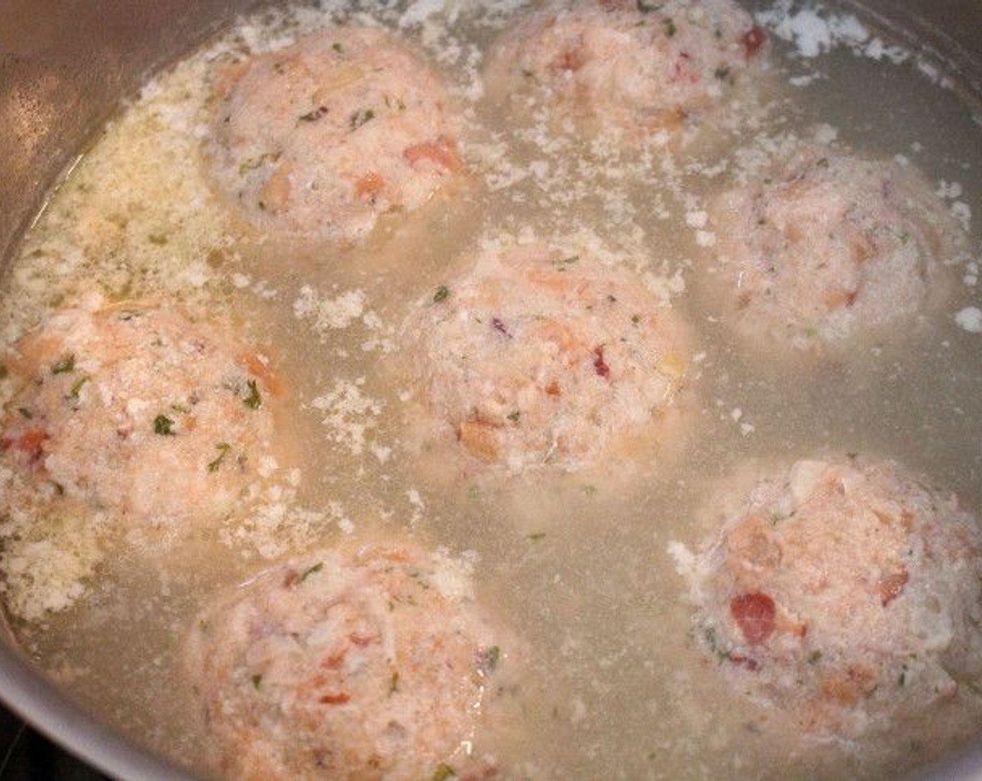 step 10 Form tennis-ball size dumplings with the mixture. Simmer in salted water until cooked through, about 25 minutes.