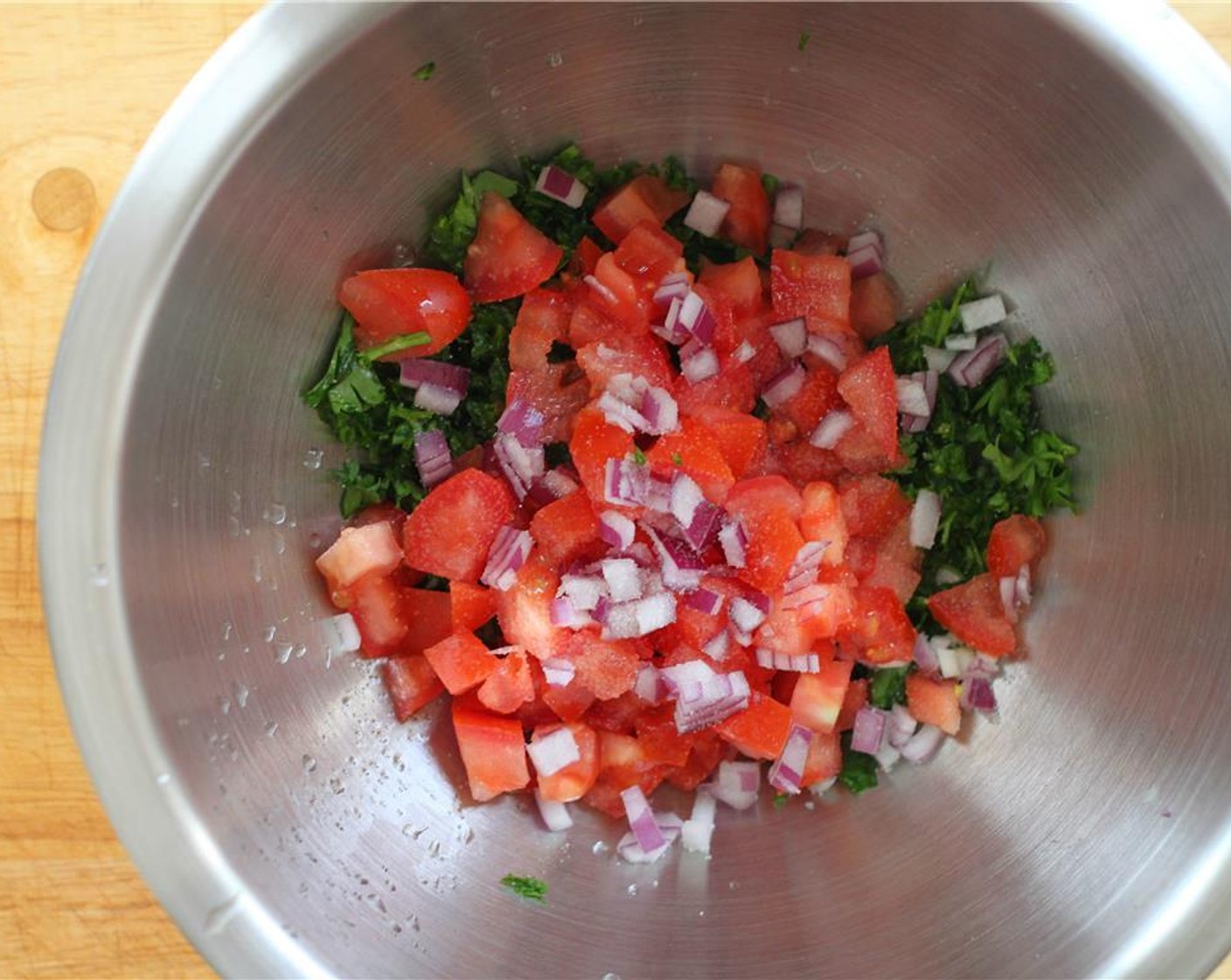 step 6 For the Quick Tabbouleh Salad, prepare the ingredients. Place the Tomato (1), Red Onion (1 Tbsp), and Fresh Parsley (1 cup) in a bowl and simply toss them together. Season with Salt (to taste) Ground Black Pepper (to taste).