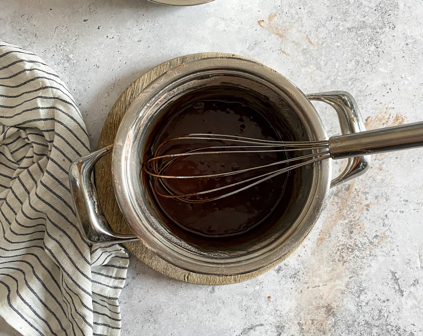 step 7 Prepare the icing. In a small pot, melt the Salted Butter (1/3 cup), then sieve the Powdered Confectioners Sugar (1 1/2 cups), and Unsweetened Cocoa Powder (2 Tbsp) into the pot. Add the Yogurt (3 Tbsp) and Vanilla Essence (1 tsp) and whisk until smooth.