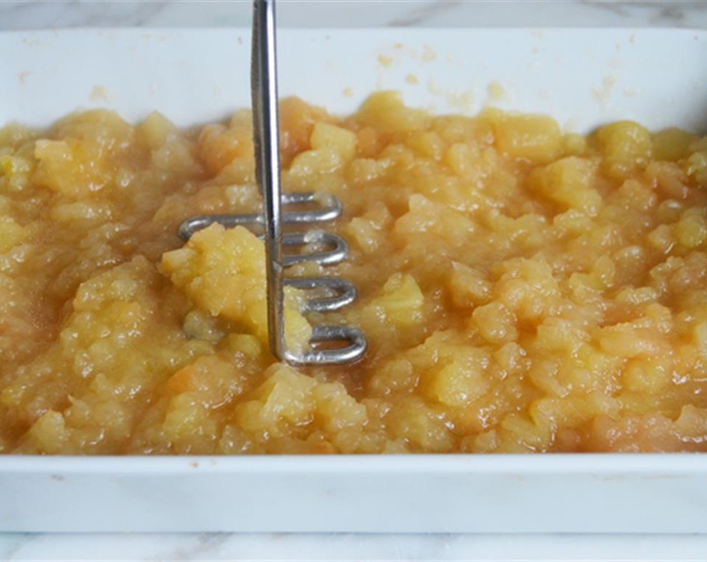 step 6 Mash the apples with a potato masher or fork. Taste the apples. If the applesauce is too tart, add more brown sugar little by little until the flavors are balanced