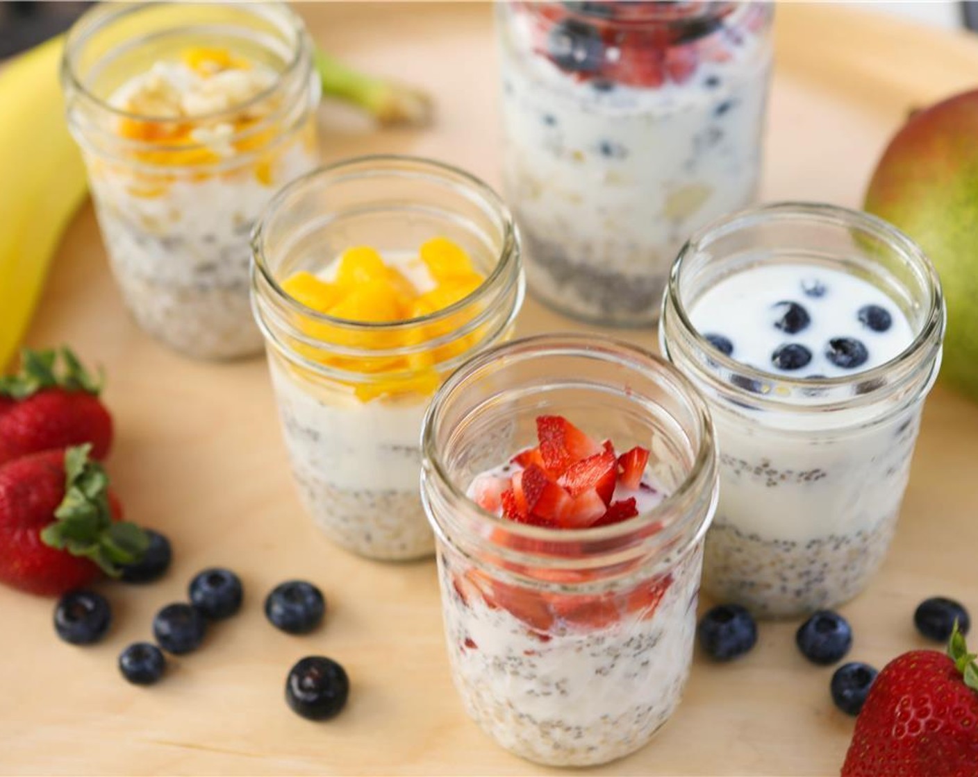 step 1 Place Old Fashioned Rolled Oats (1/4 cup), Chia Seeds (1/2 Tbsp), Milk (1/2 cup), Mangoes (to taste), Fresh Blueberries (to taste), Raisins (to taste), Ground Cinnamon (to taste), Honey (to taste), and Vanilla Extract (to taste) in a half-pint mason jar.