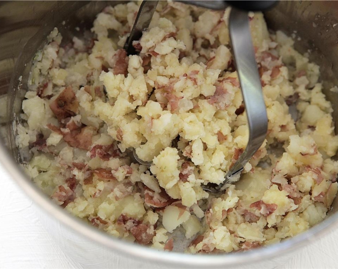 step 5 While the mushroom are cooking, drain the potatoes in a colander and put them back in the pot they cooked in. Add Rosemary Sea Salt (1 tsp), remaining Unsalted Butter (0.5 oz) and smash with a potato masher or kitchen spoon until fully incorporated.
