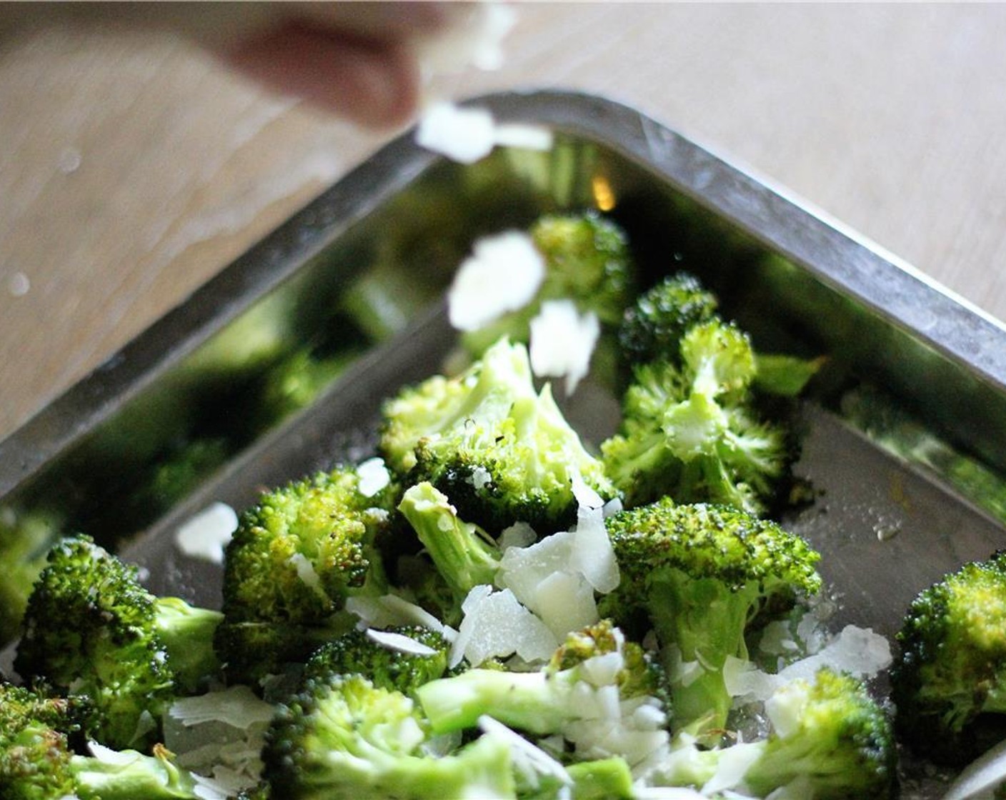 step 6 While steaks are cooking, transfer seasoned broccoli to an oven safe baking sheet or pan and bake for 10-12 minutes, or until broccoli is tender. Remove from oven and sprinkle with the Parmesan Cheese (1/4 cup) while still warm.