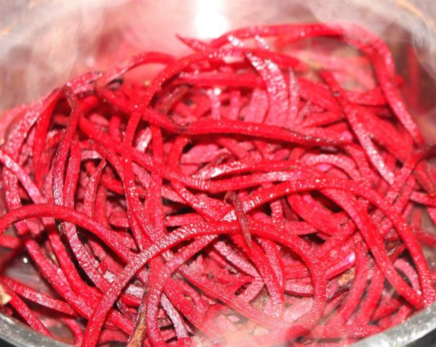 step 2 Use a spiralizer to cut red beets into thin, long strands.