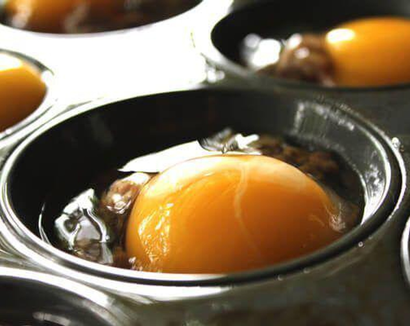step 4 Crack an Eggland's Best Classic Eggs (12) in each muffin tin. Gently break the yolk, and with the handle end of a spoon or fork, gently move the sausage around to allow the egg to seep through to the bottom.