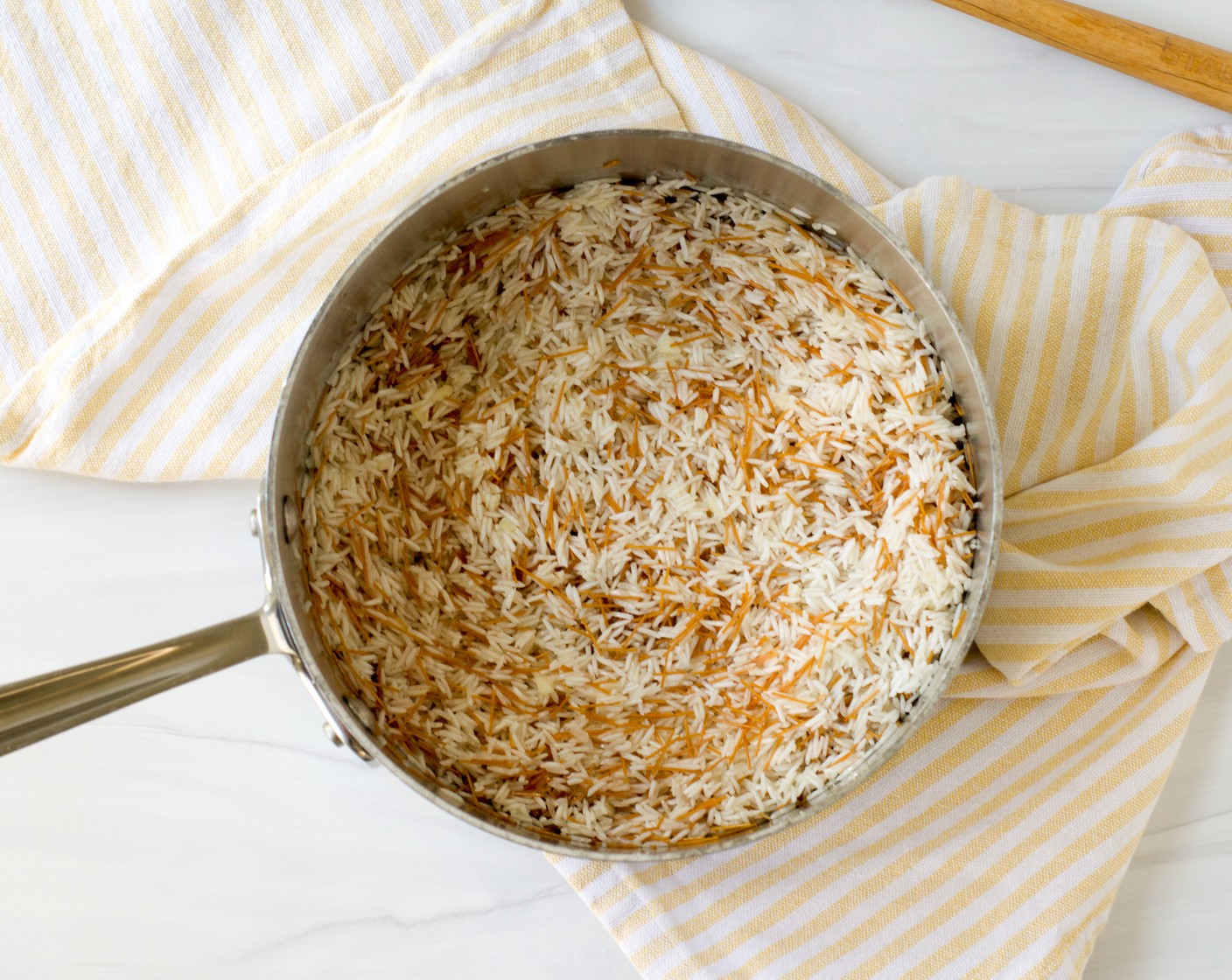 step 2 Add the Garlic (1 clove) and sauté just until fragrant, about 30 seconds. Add the Long Grain White Rice (1 1/2 cups) and stir to coat the grains with the ghee.