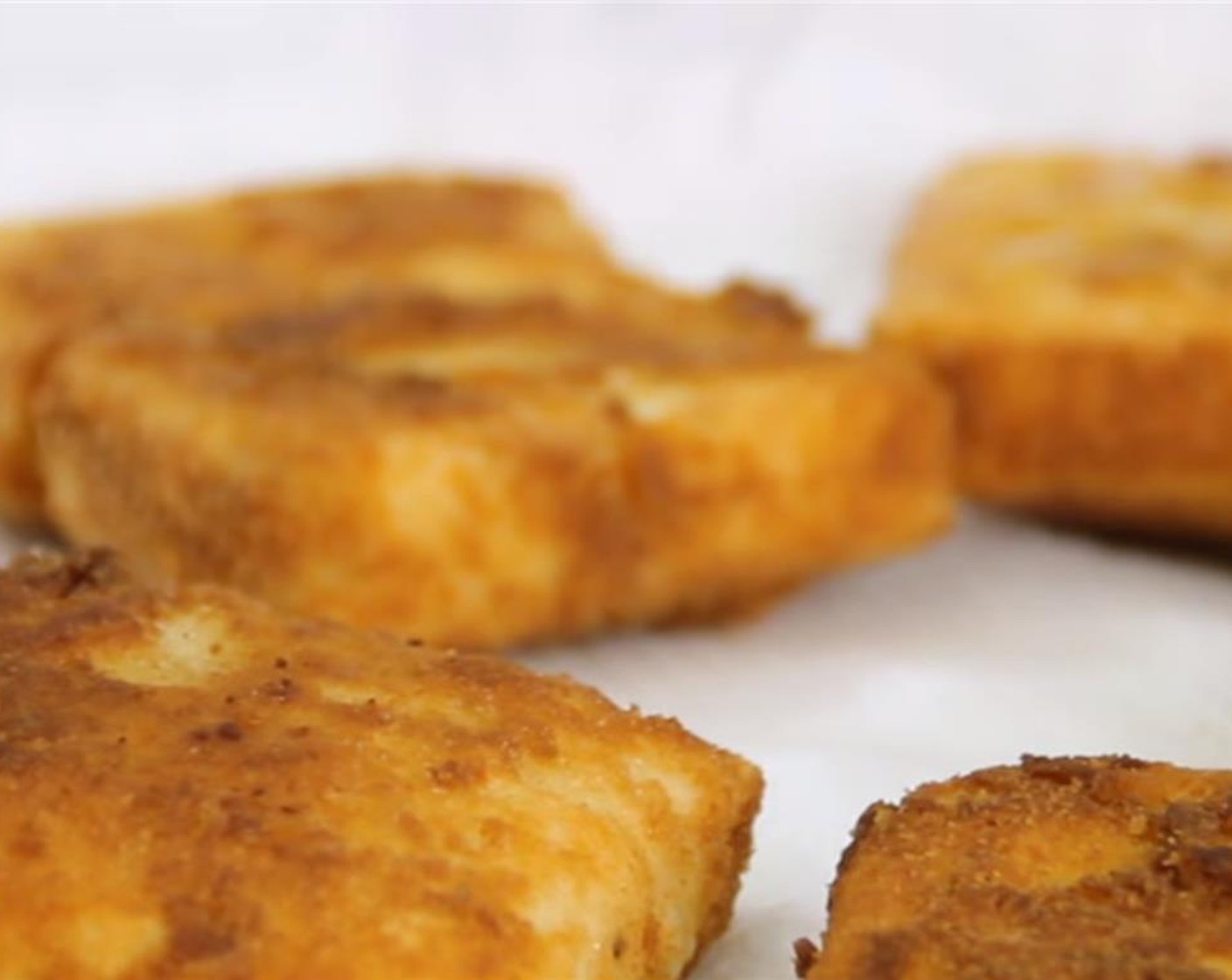 step 11 Place the tofu in and fry it, in batches, for about 1 1/2 minutes on each side. Remove the tofu and set it aside on a plate lined with a paper towel.