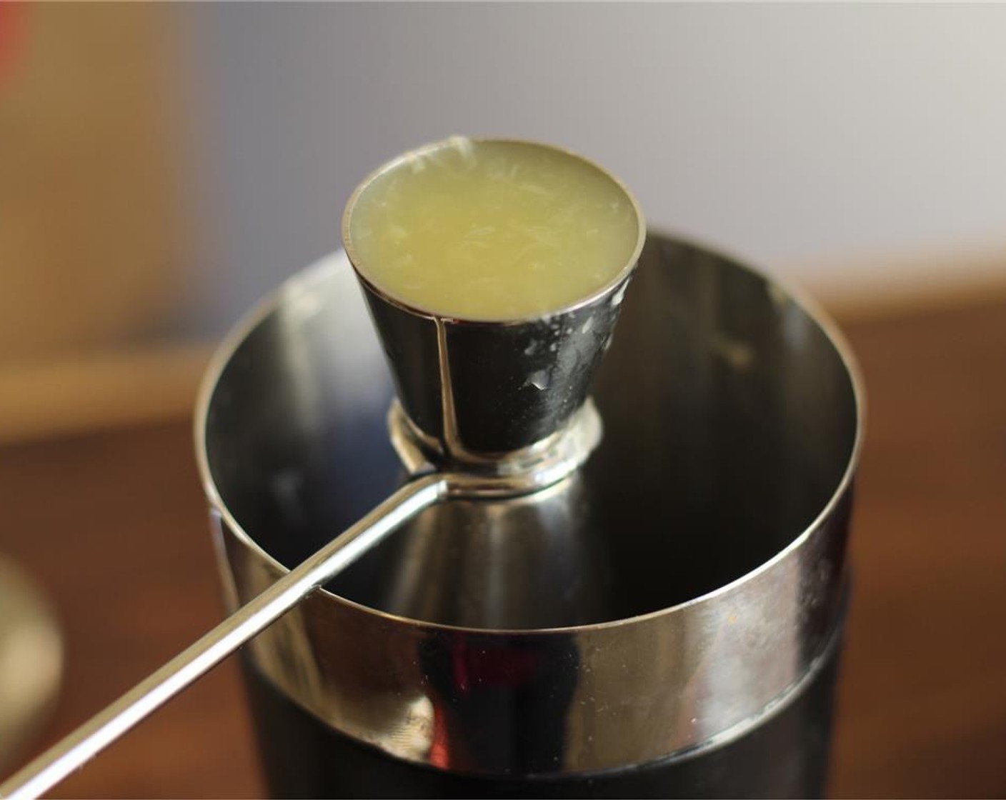 step 1 Add Simple Syrup (0.8 fl oz) and the juice from Meyer Lemon (1) to a cocktail shaker.