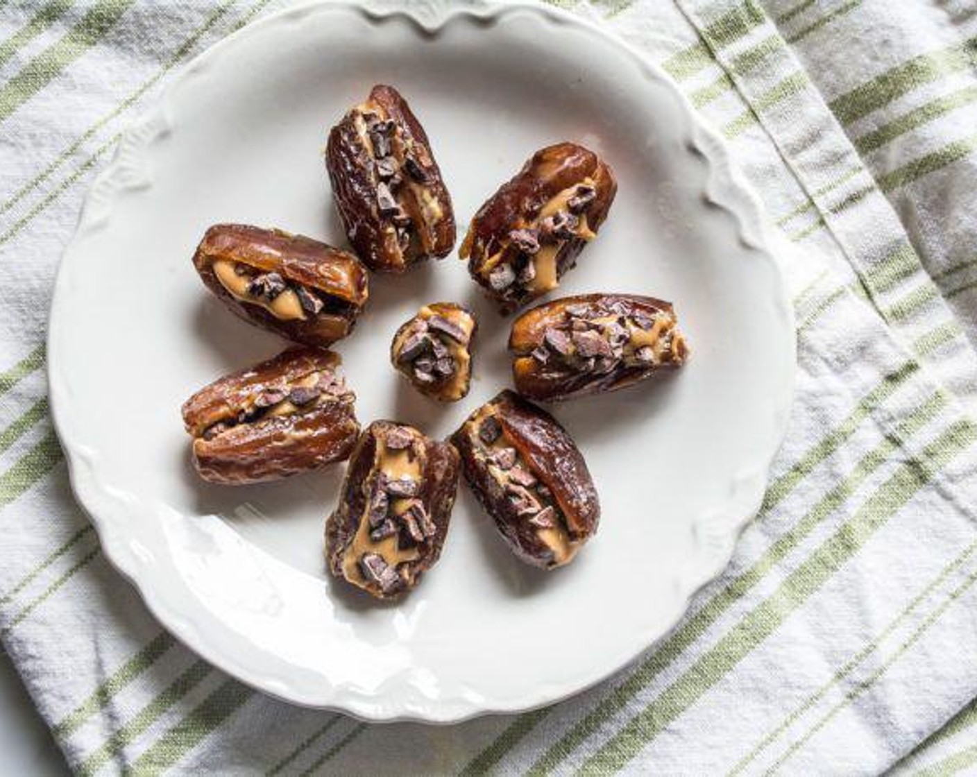 step 1 Slice Deglet Dates (24) down the center lengthwise, add Peanut Butter (1/4 cup), and sprinkle evenly with Cacao Nibs (1/4 cup). Serve and enjoy!