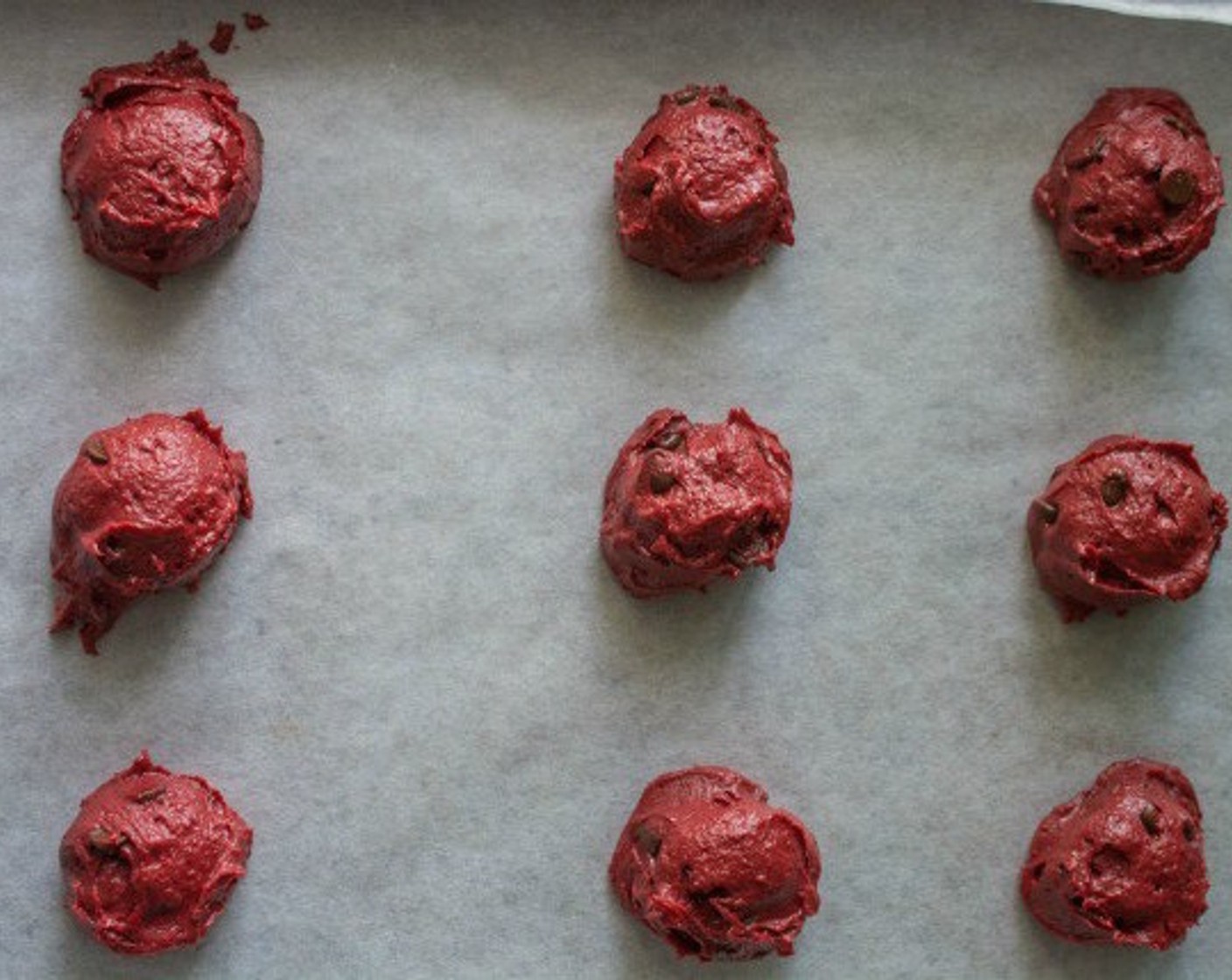 step 8 Line a baking sheet with parchment paper. Scoop heaping tablespoons of the cookie dough onto the baking sheets, leaving about 2 inches of space in between each cookie.