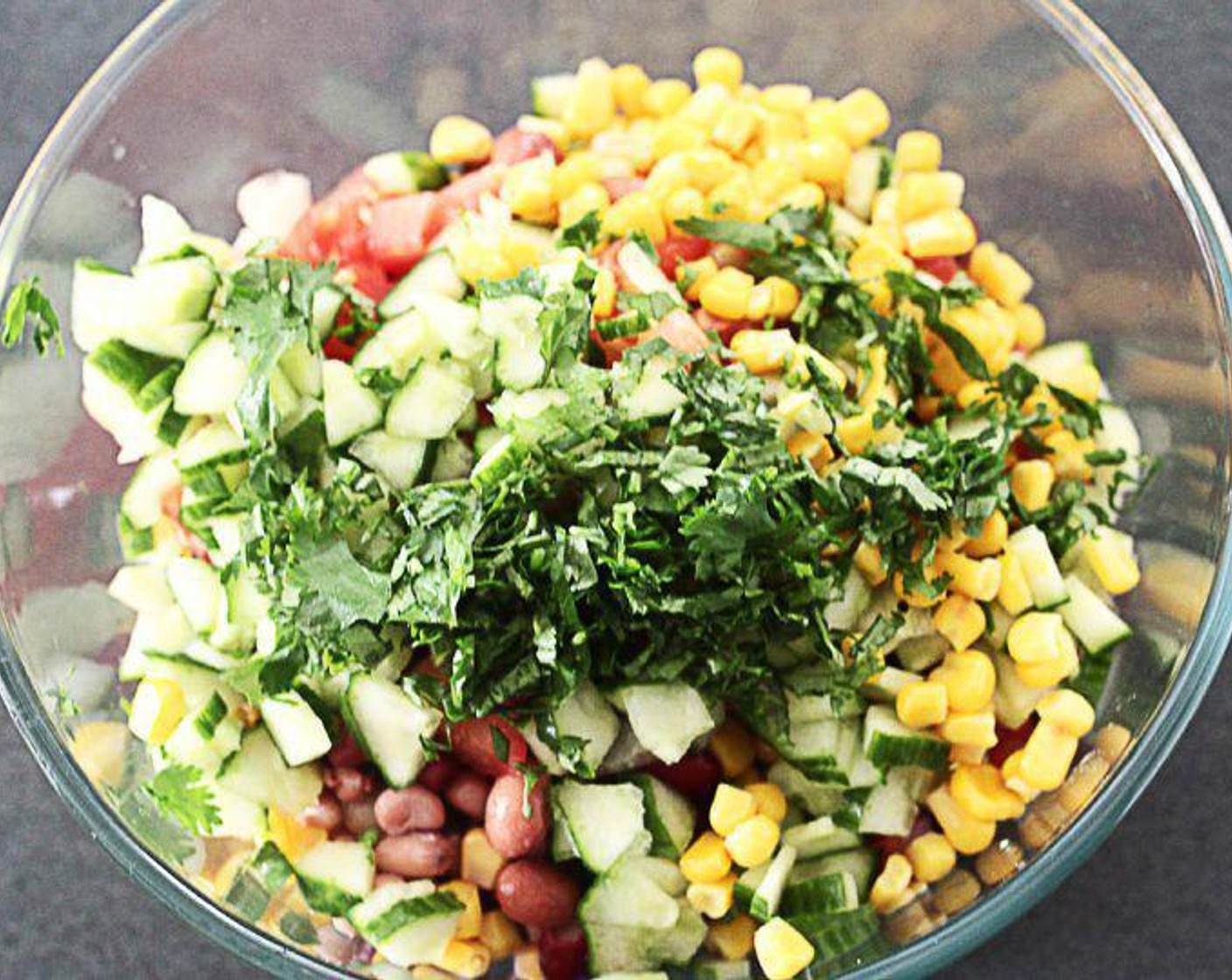 step 1 In a large mixing bowl, combine Quinoa (1 3/4 cups), Canned Corn (2/3 cup), Canned Black Beans (1 1/3 cups), Tomato (1), Cucumber (1/2), Garlic (2 cloves), Salt (1/2 tsp), Paprika (1/2 tsp), Ground Turmeric (1/2 tsp), Olive Oil (1 Tbsp), Lime (1/2), Apple Cider Vinegar (1 tsp), and Jalapeño Peppers (2).